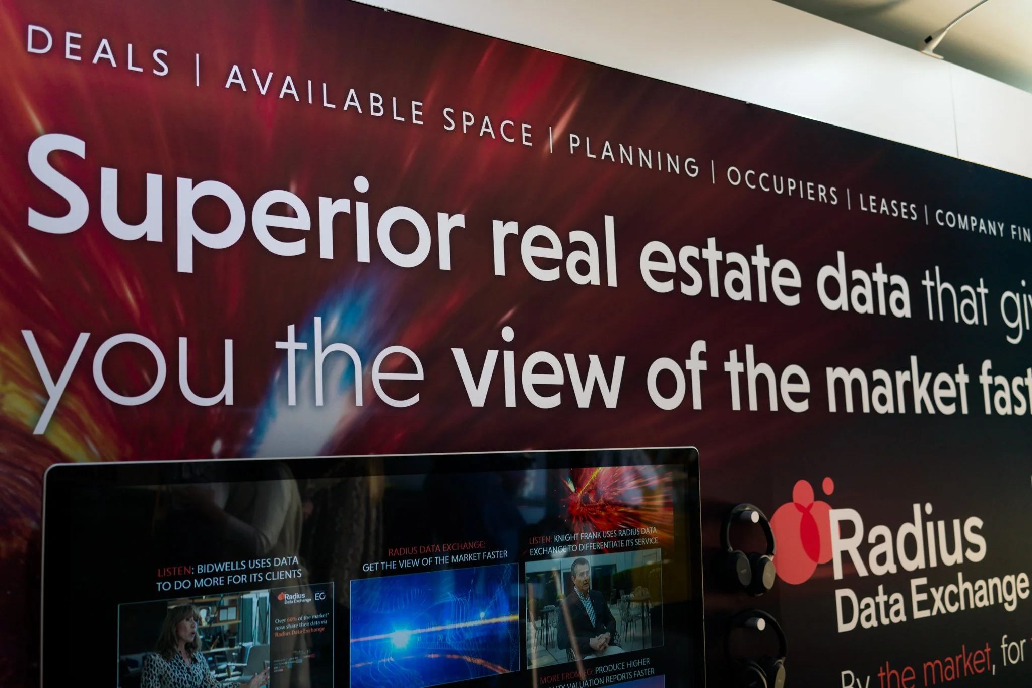 Advertisement for Radius Data Exchange with the slogan "Superior real estate data that gives you the view of the market fast". The banner displays digital images and mentions data services related to real estate, with the Radius Data Exchange logo an