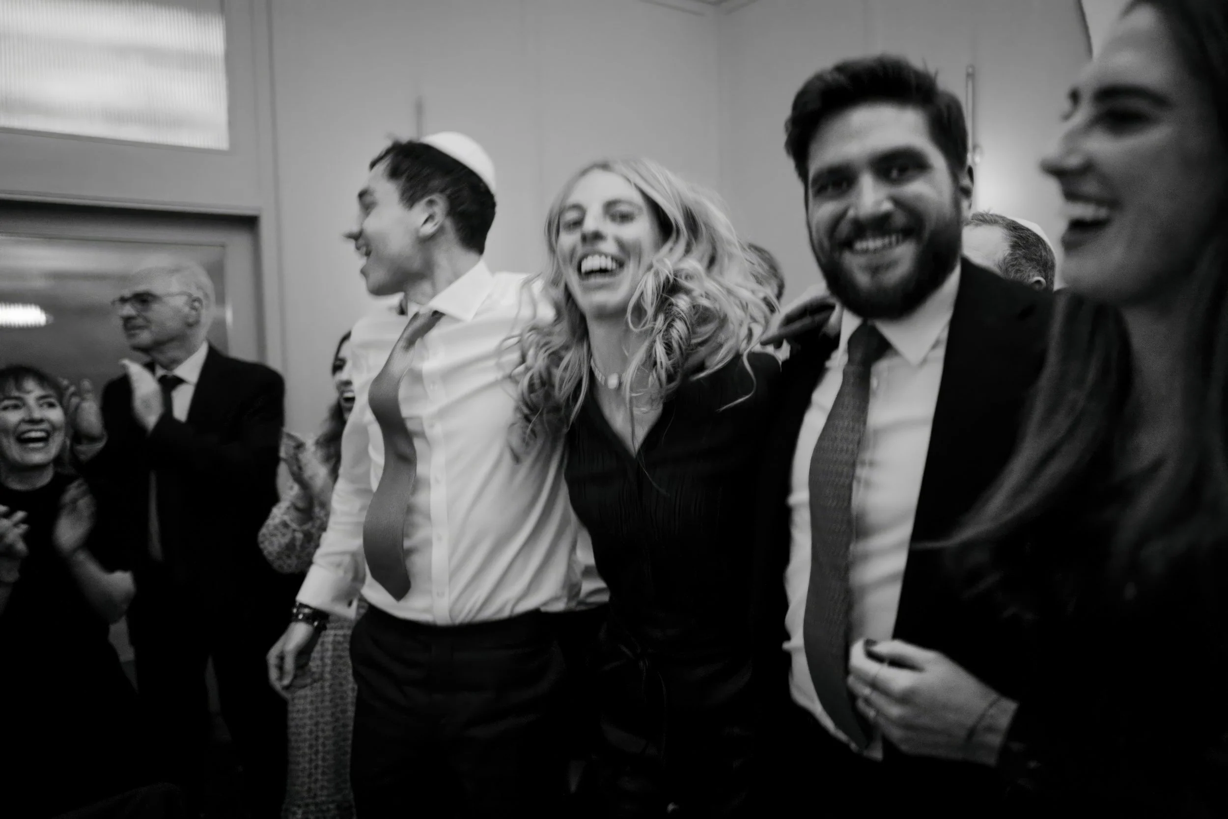 Group of people celebrating and smiling at a gathering or event.