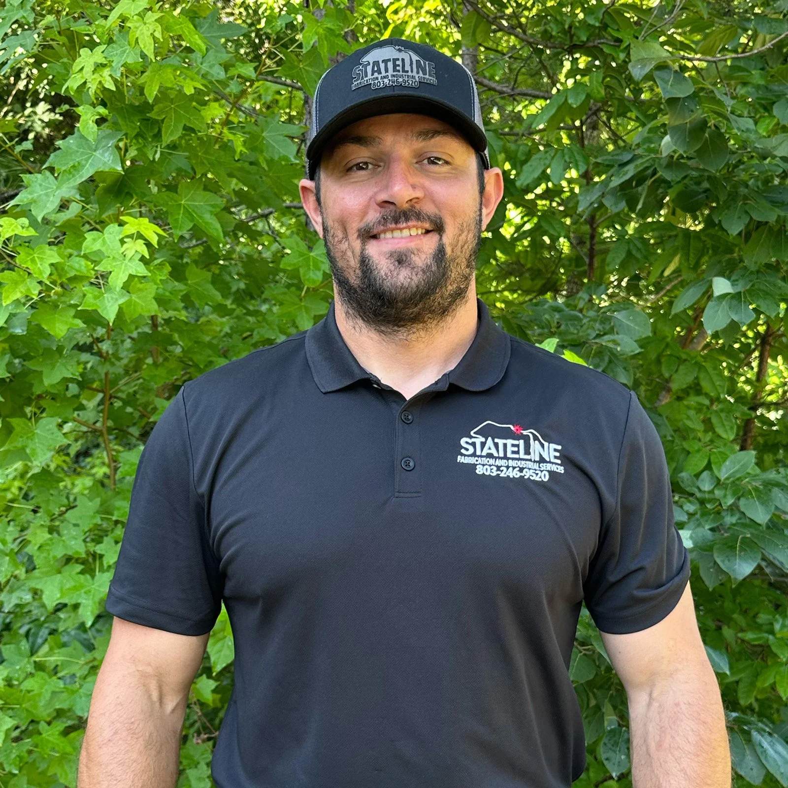 Chase Watson, standing outdoors at Stateline Fabrication wearing a black polo