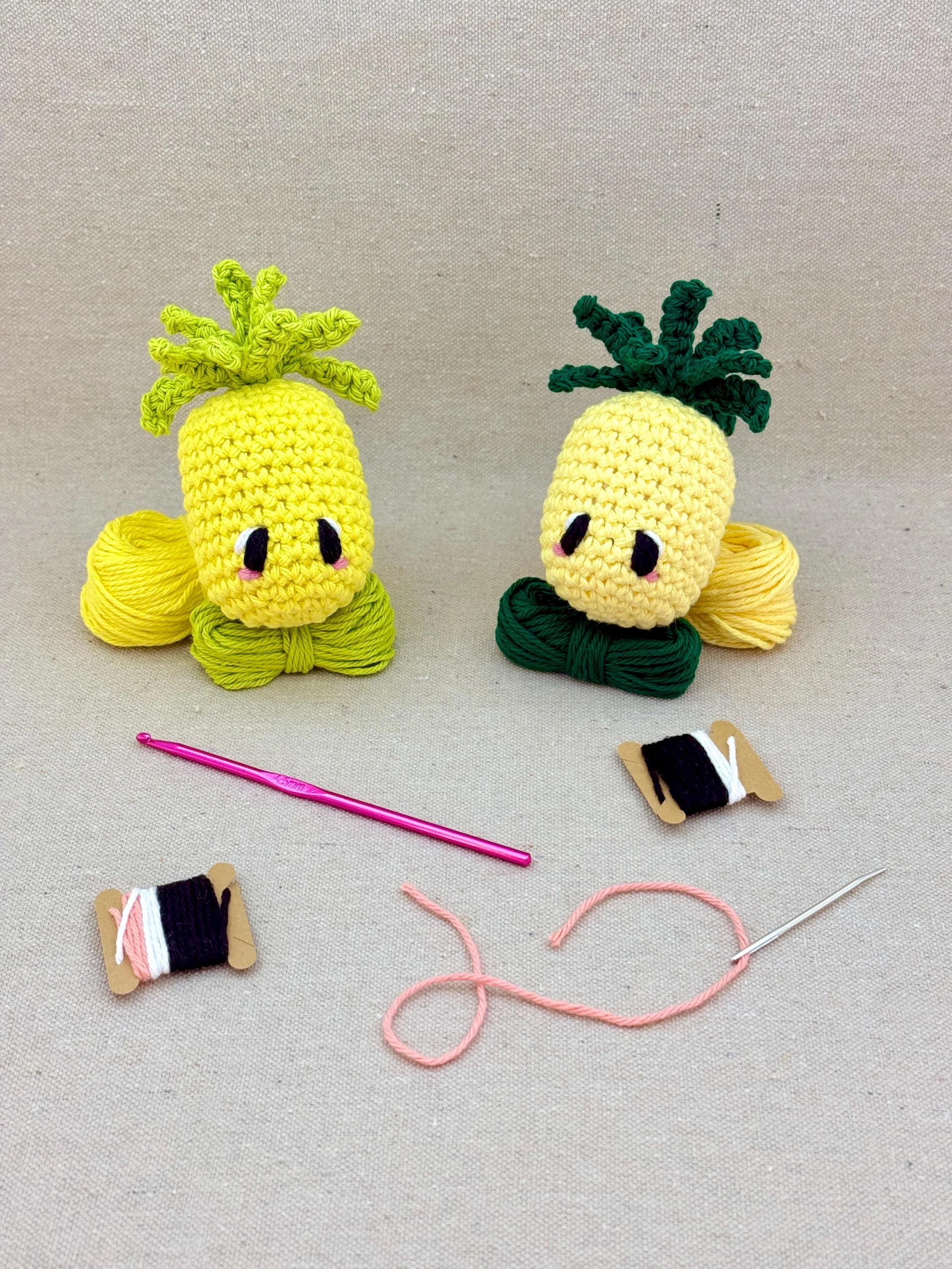 Two amigurmi pineapples in bright yellow and butter yellow on matching colour yarn (Copy)