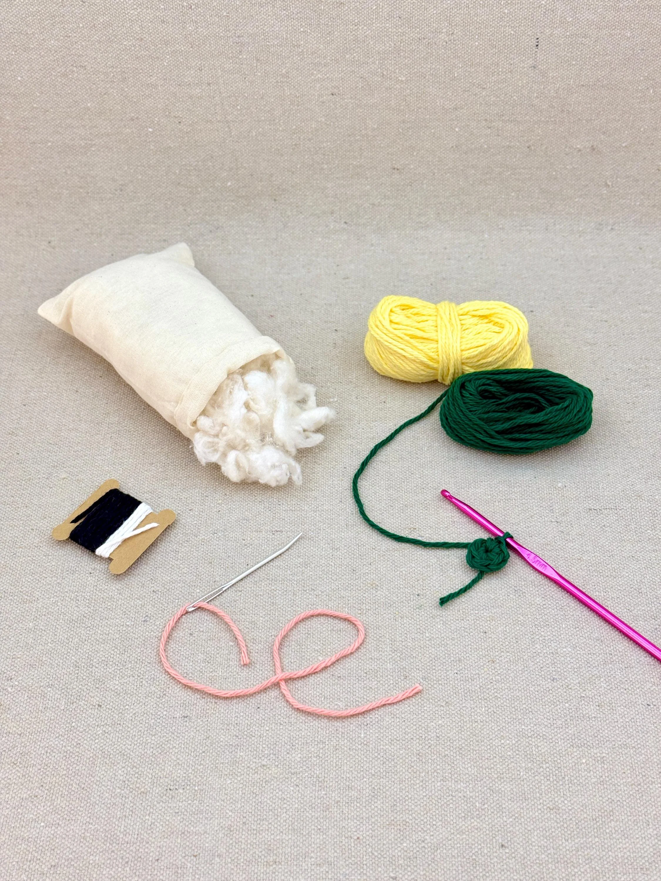 A butter yellow amigurumi pineapple mid project using a DIY crochet kit (Copy)