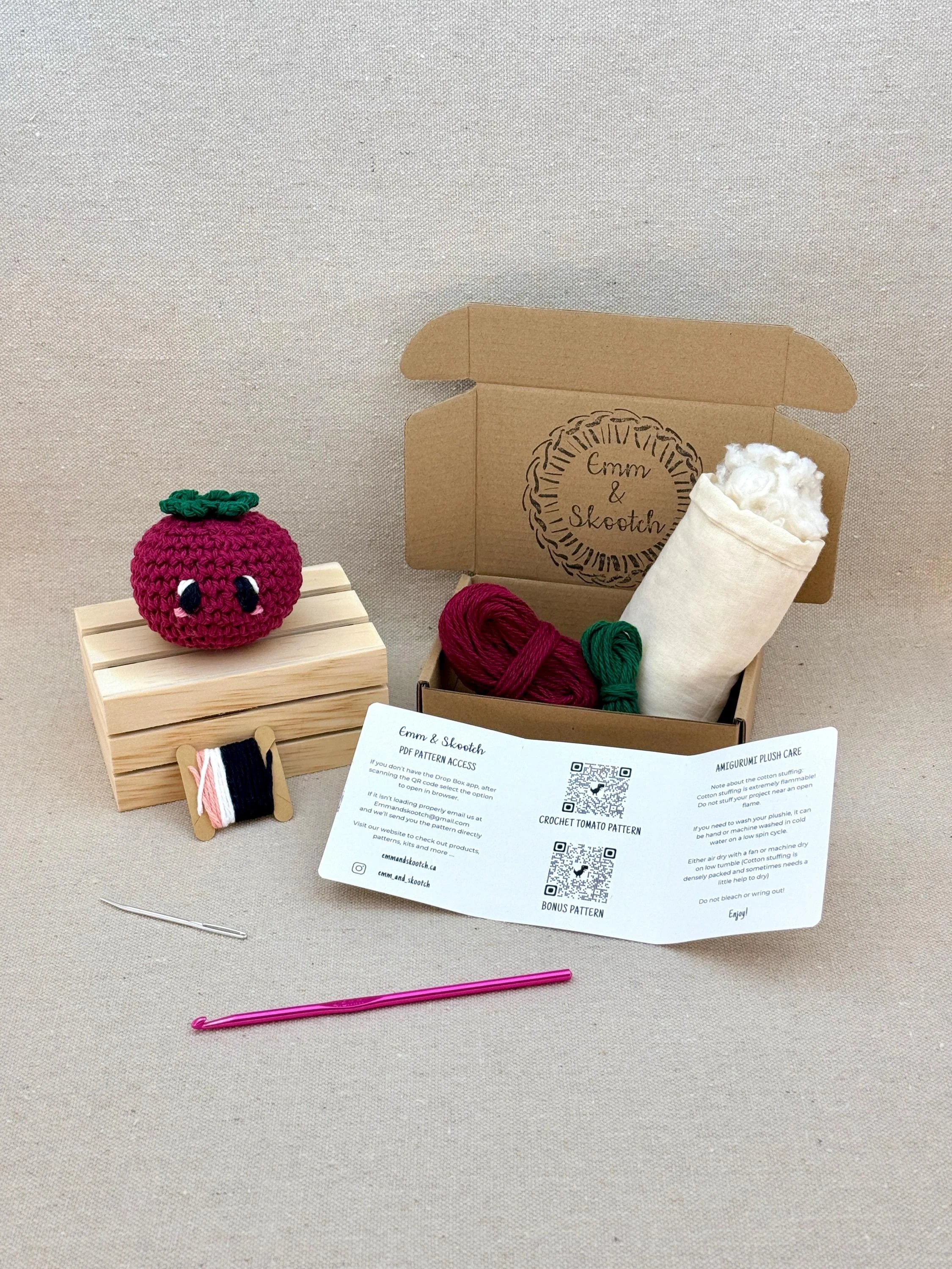 A finished burgundy amigurumi tomato with the DIY Crochet Kit
