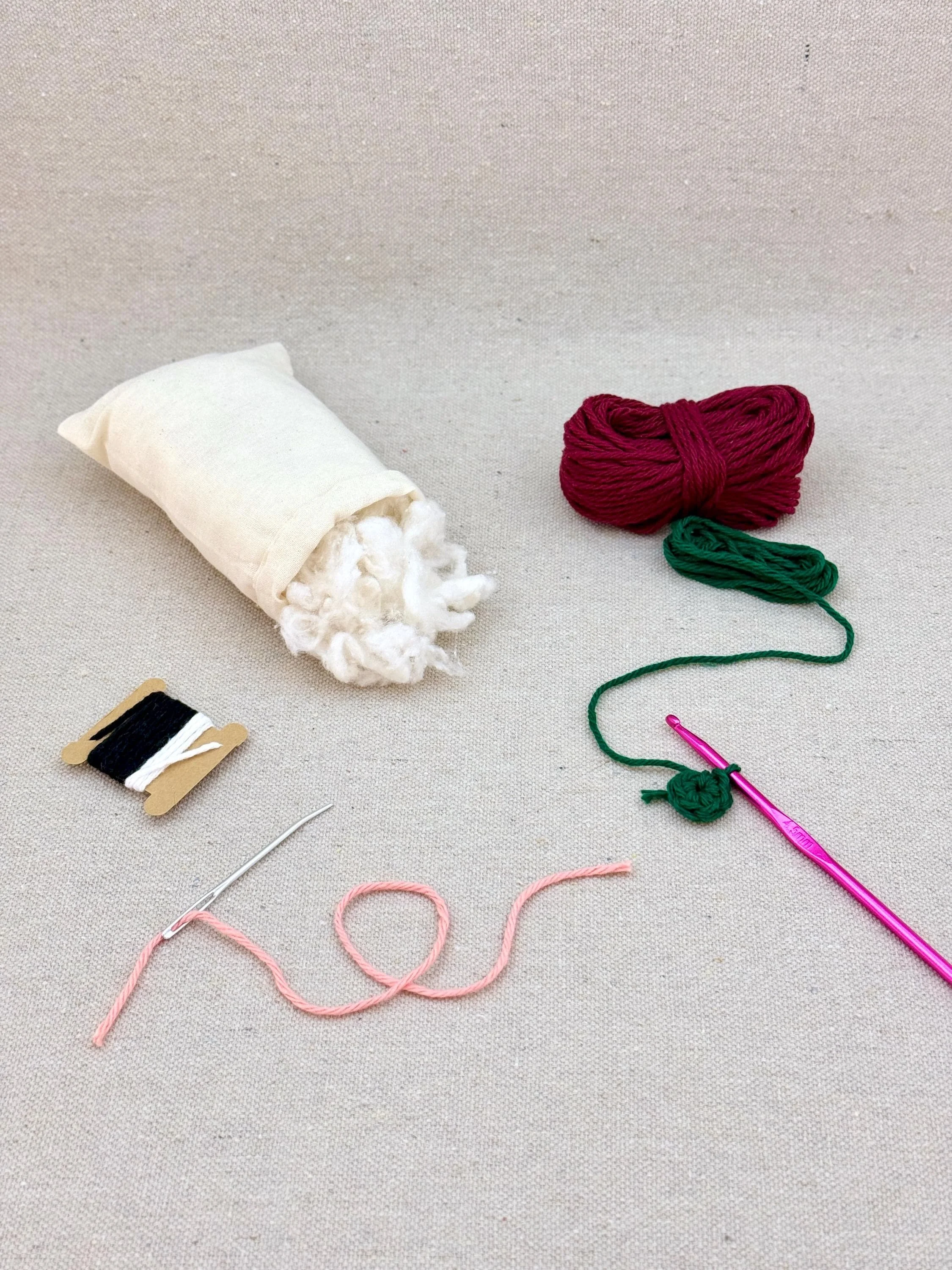 A burgundy amigurumi tomato mid project using a DIY crochet kit (Copy)