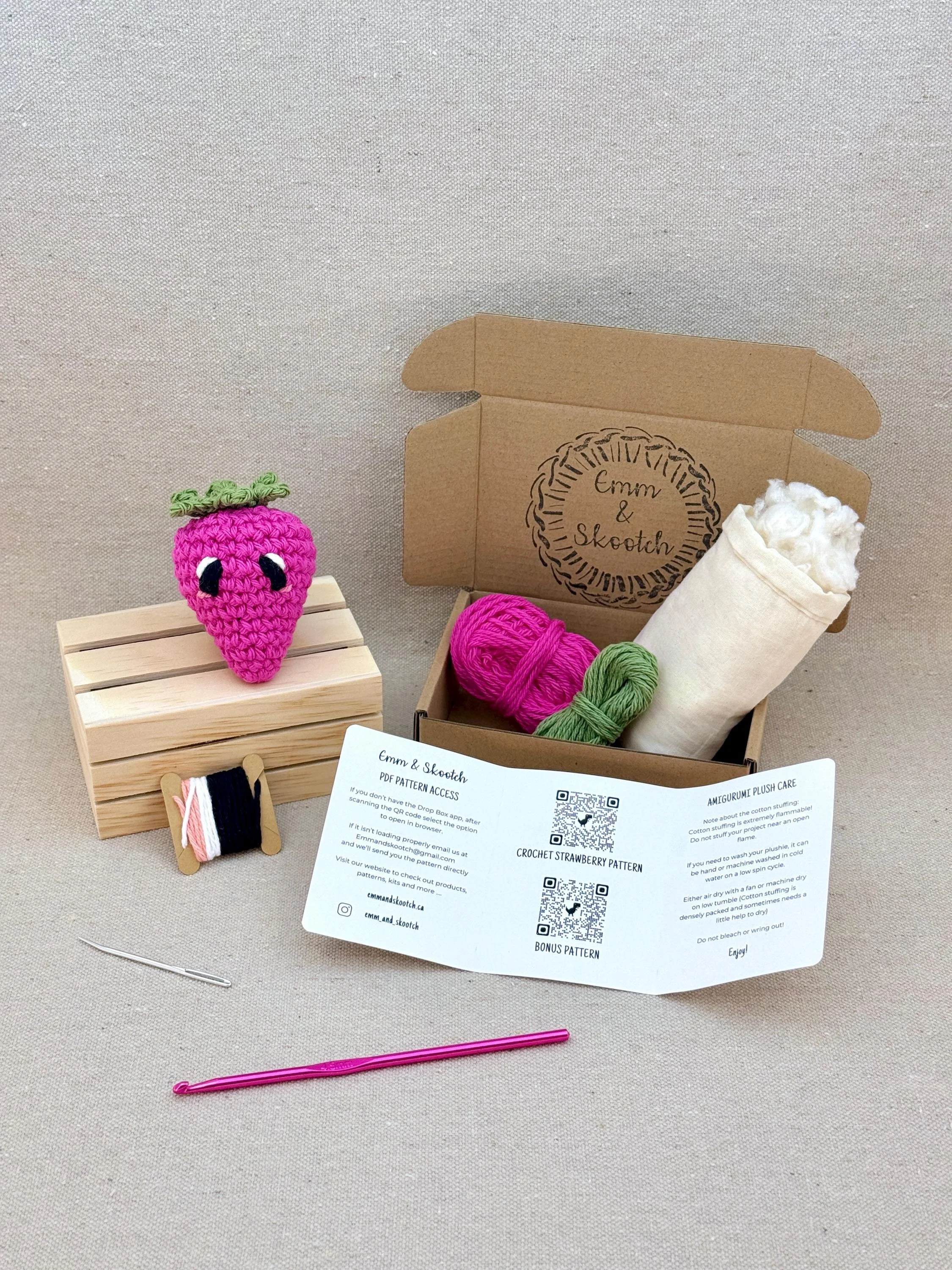 A finished hot pink amigurumi strawberry with the DIY Crochet Ki