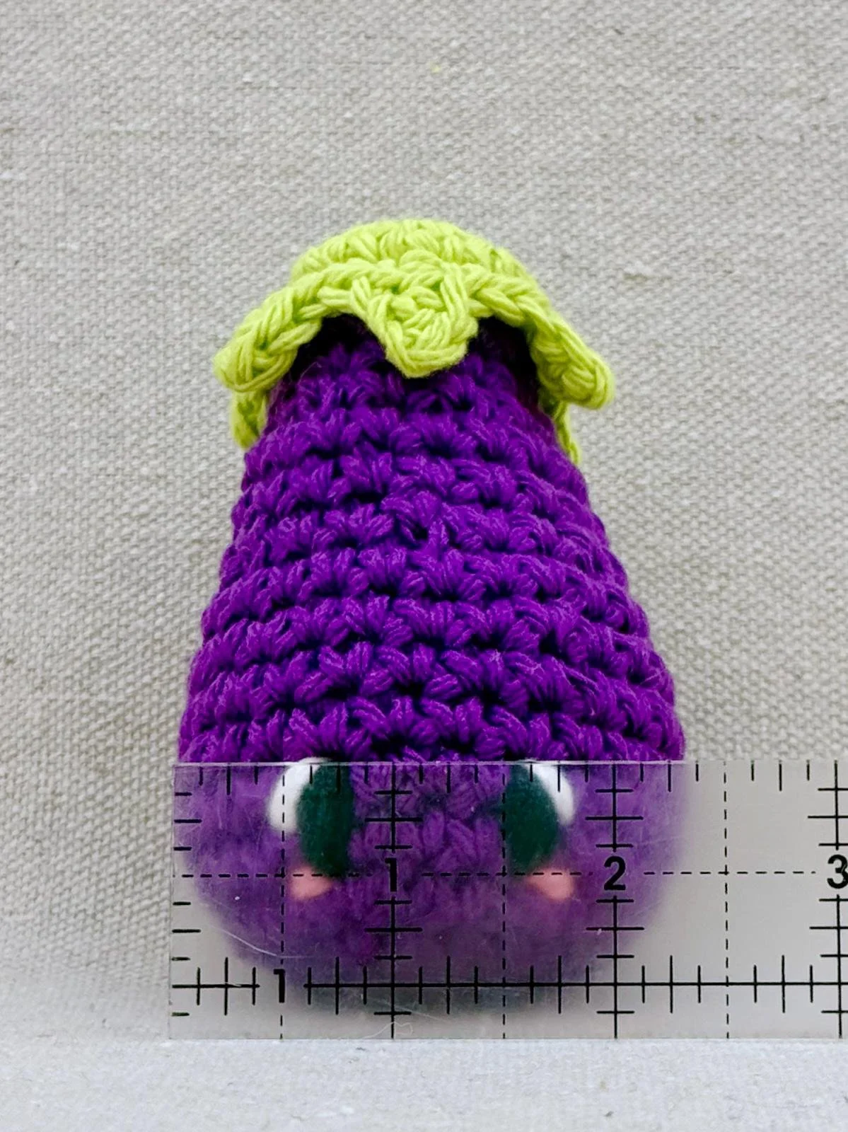 Amigurumi eggplant measuring 2.375 inches wide
