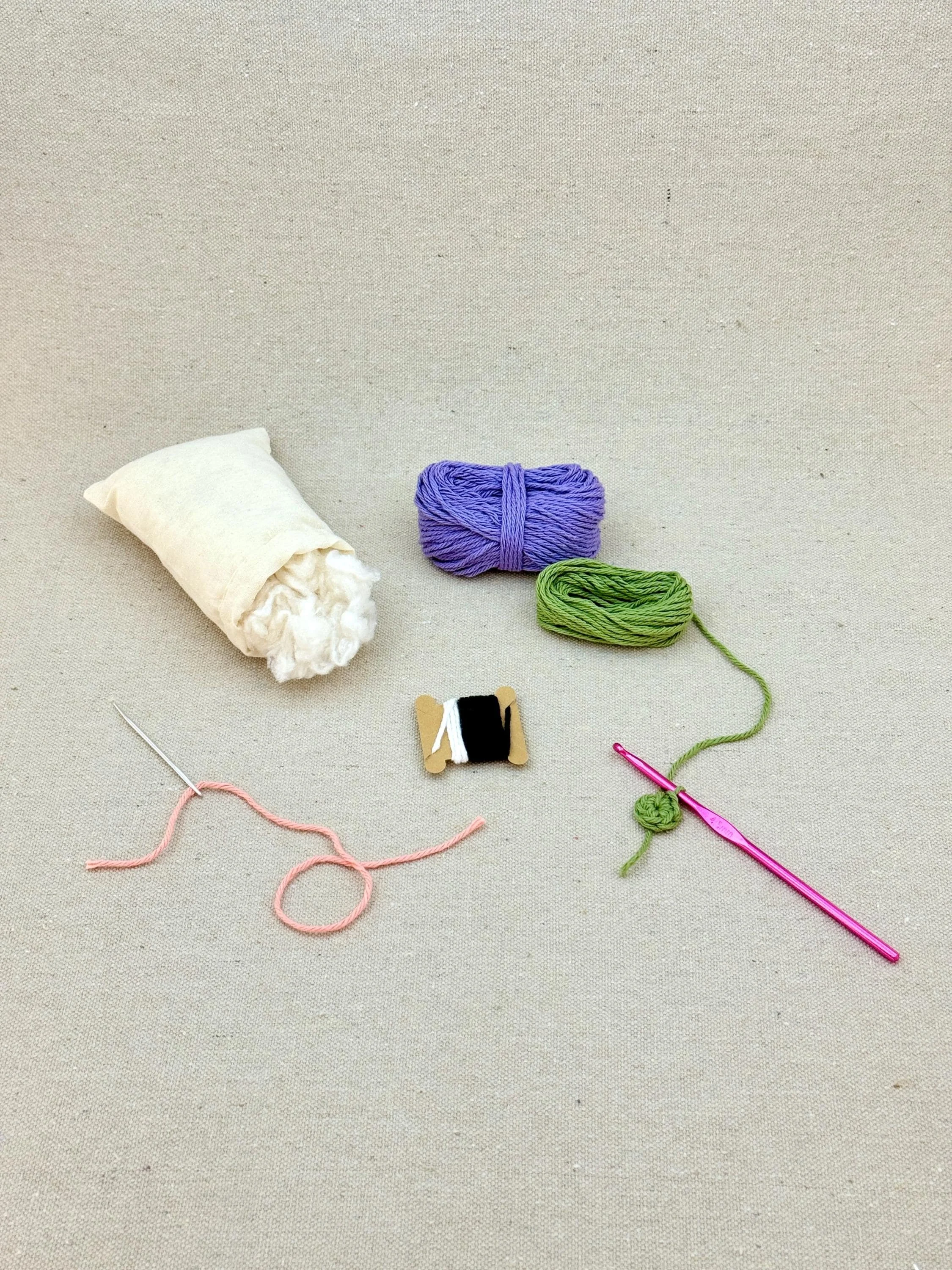 A light purple amigurumi eggplant mid project using a DIY crochet kit