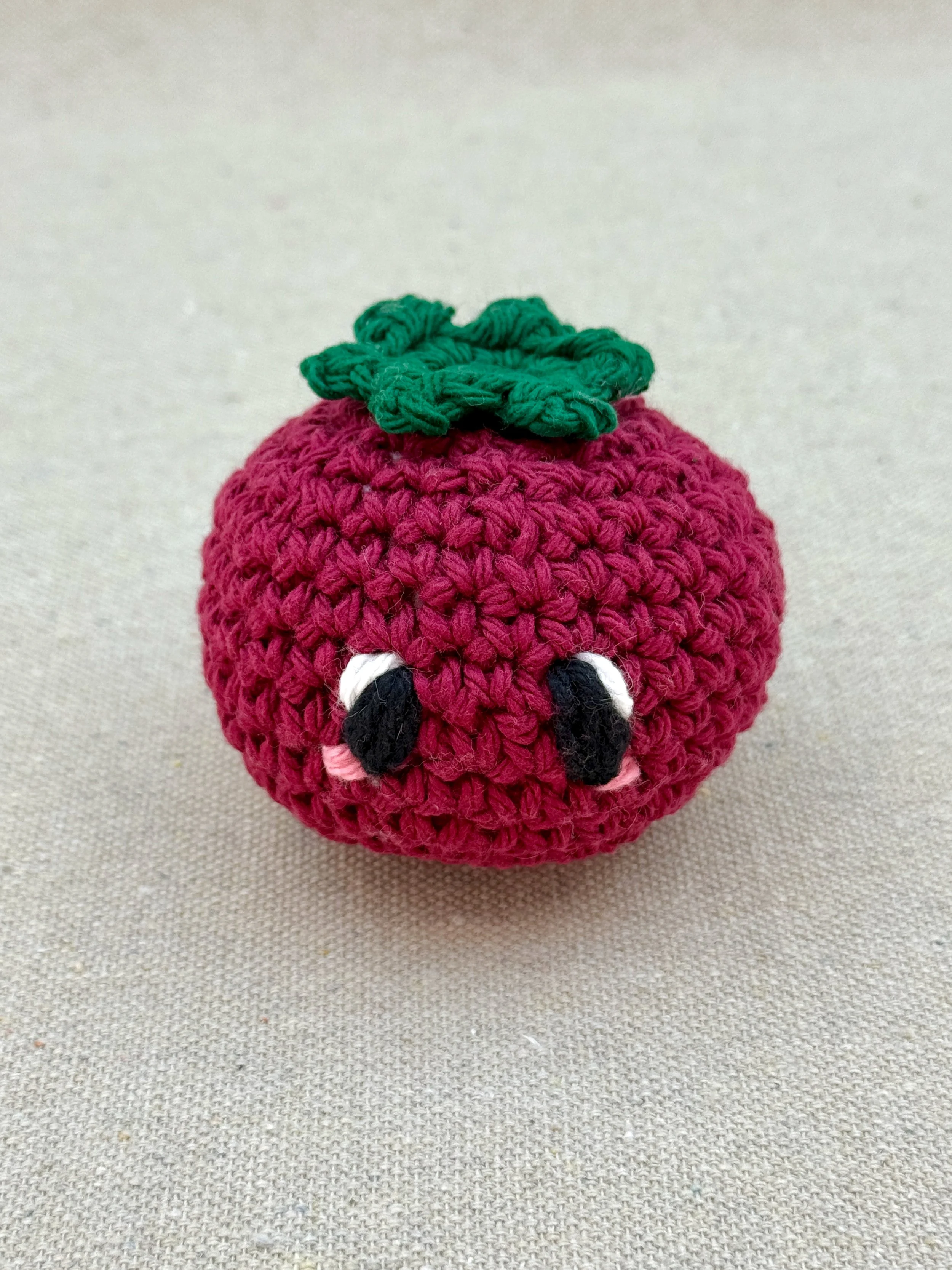 Burgundy-Eco-Friendly-åClose up of a burgundy tomato amigurumi plush made from cotton yarn and cotton stuffingCotton-Crochet-Tomato-Plushie-2.jpeg (Copy)