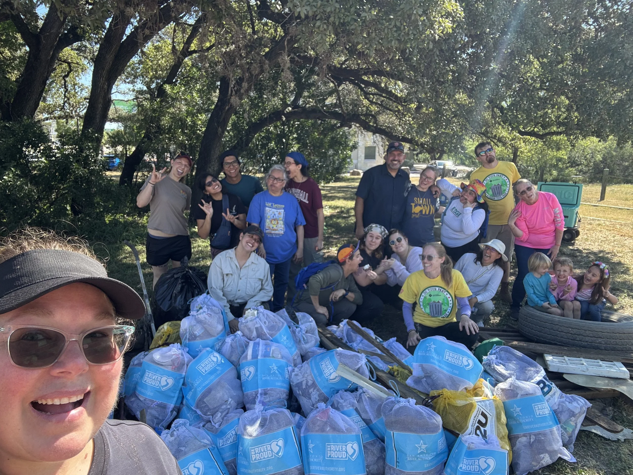 volunteers in front of collected trash at Salado Creek