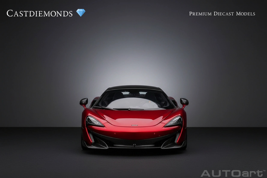 Red sports car with black accents facing forward in a studio setting with gray background