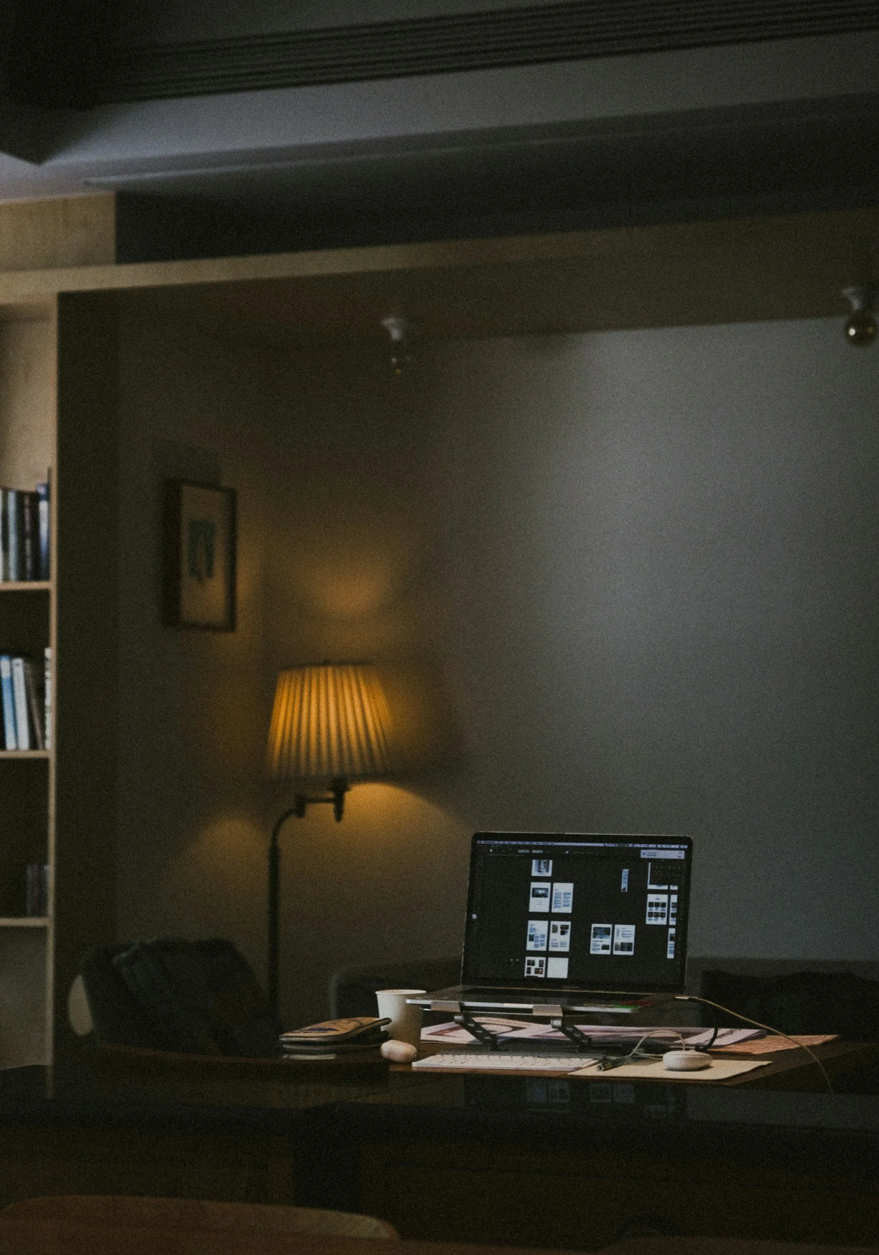 Gemütlicher Arbeitsplatz mit schummrigem Licht und grünen Wänden.