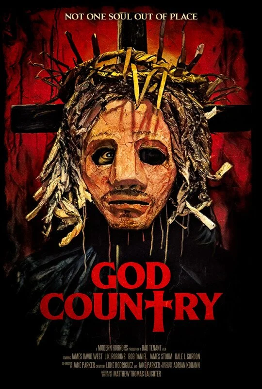 A horror movie poster titled 'God Country' featuring a grotesque mask of a face with dreadlocks and a crown of nails, hanging on a cross with a dark red background. The tagline reads 'Not one soul out of place.'
