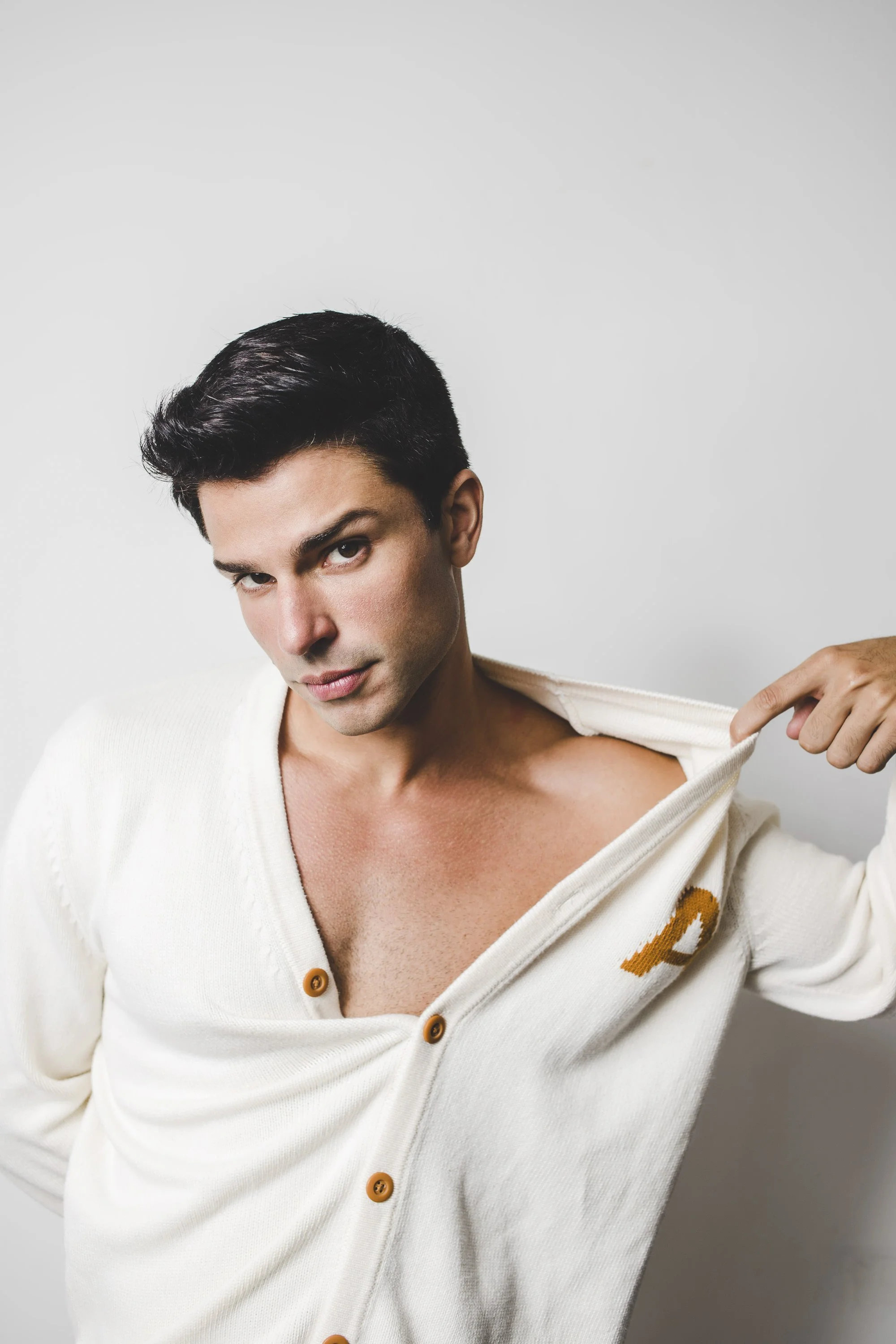 Studio portrait of actor Diego Montez photographed in a clean, minimal setting.
