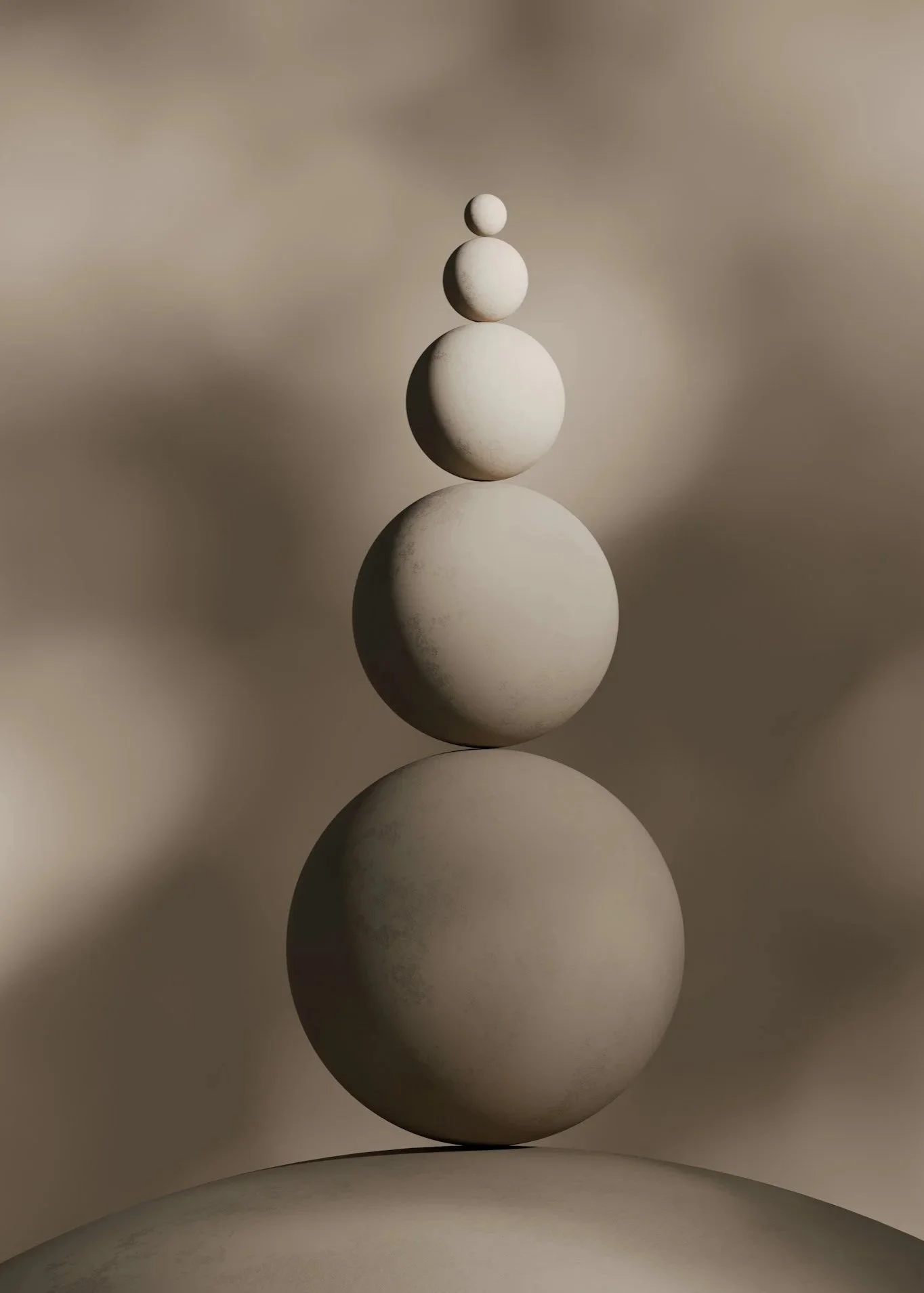 Stacked white spherical stones decreasing in size from bottom to top, with a blurred background.