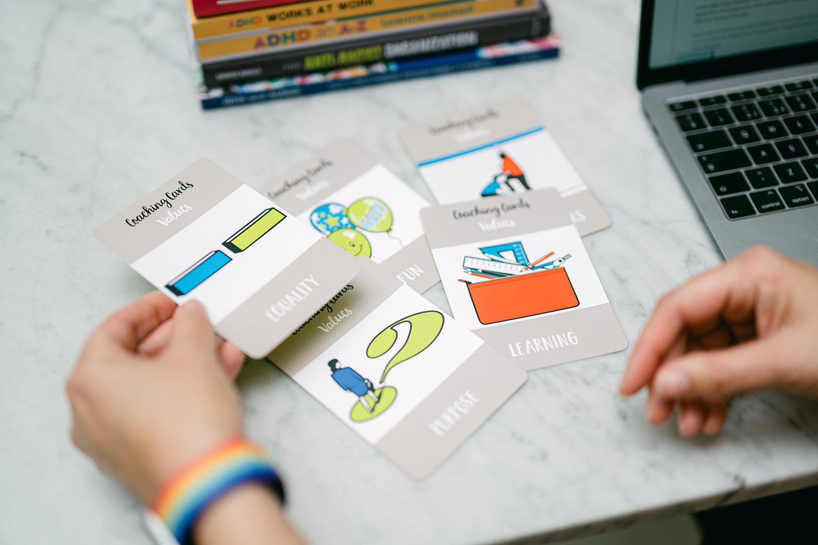 A selection of values cards spread over the table with one called "Equality" picked up.