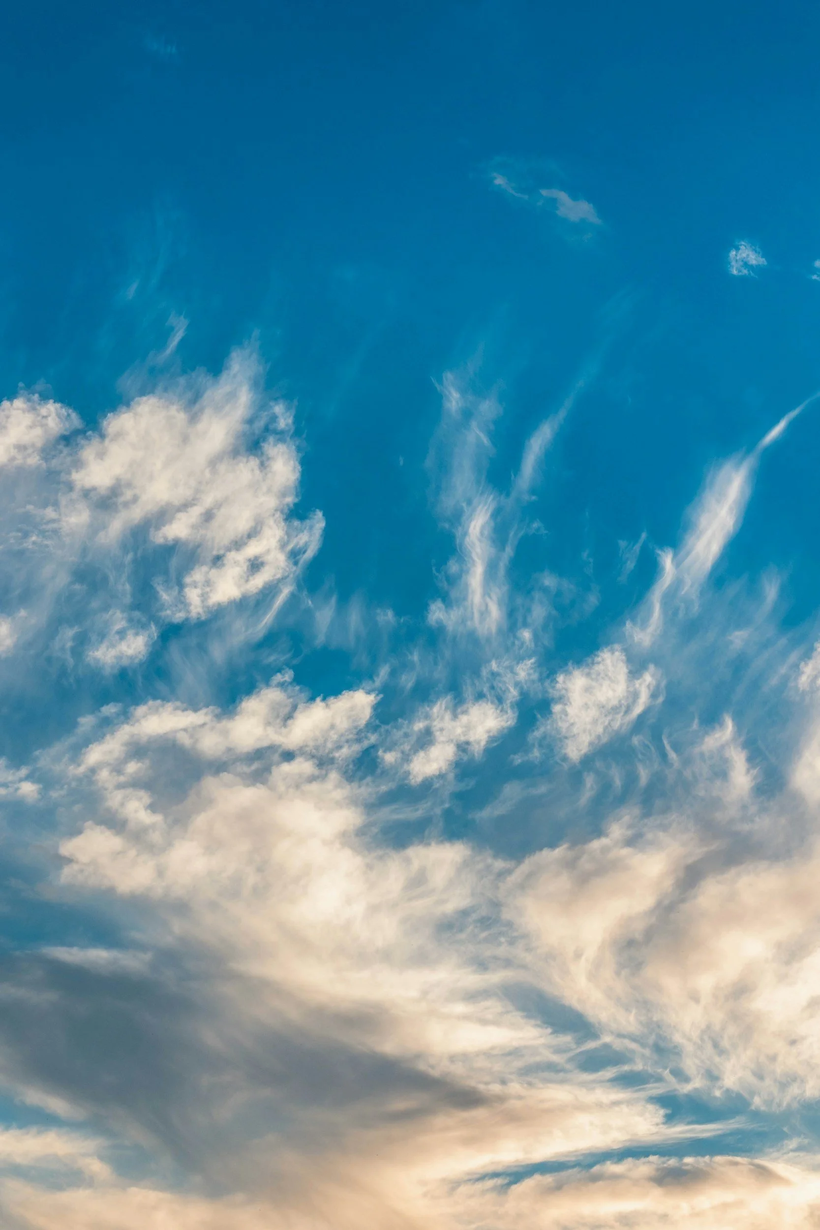 Sky with scattered white clouds during daytime.