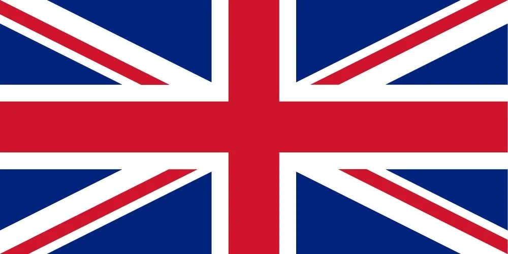 The flag of the United Kingdom with a blue field, red cross, and white outline.