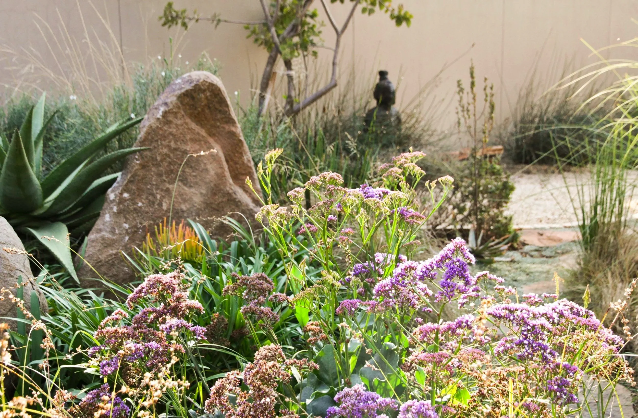 Naturalistic planting design boulder, ornamental grasses and perennials