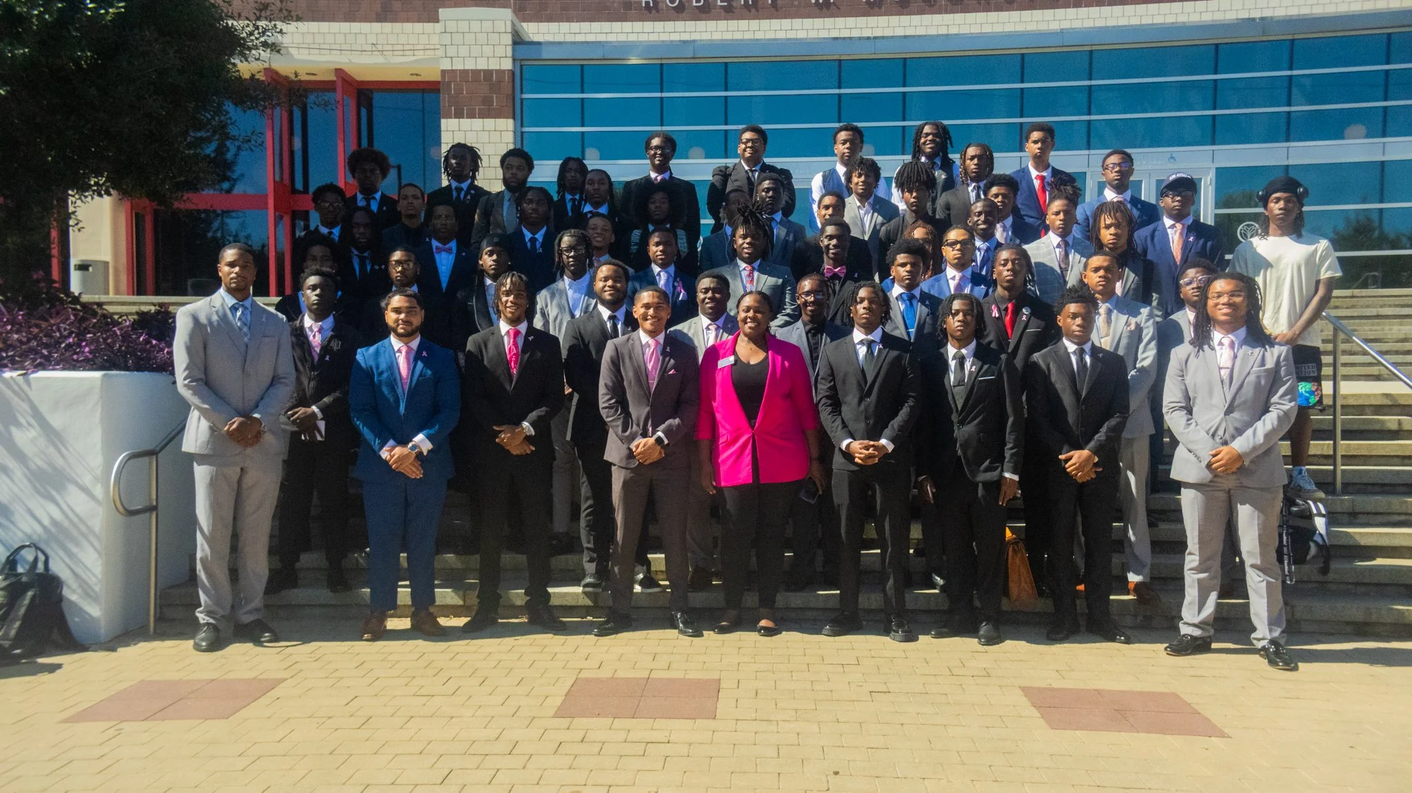 Group of well-dressed young adults outside a modern building