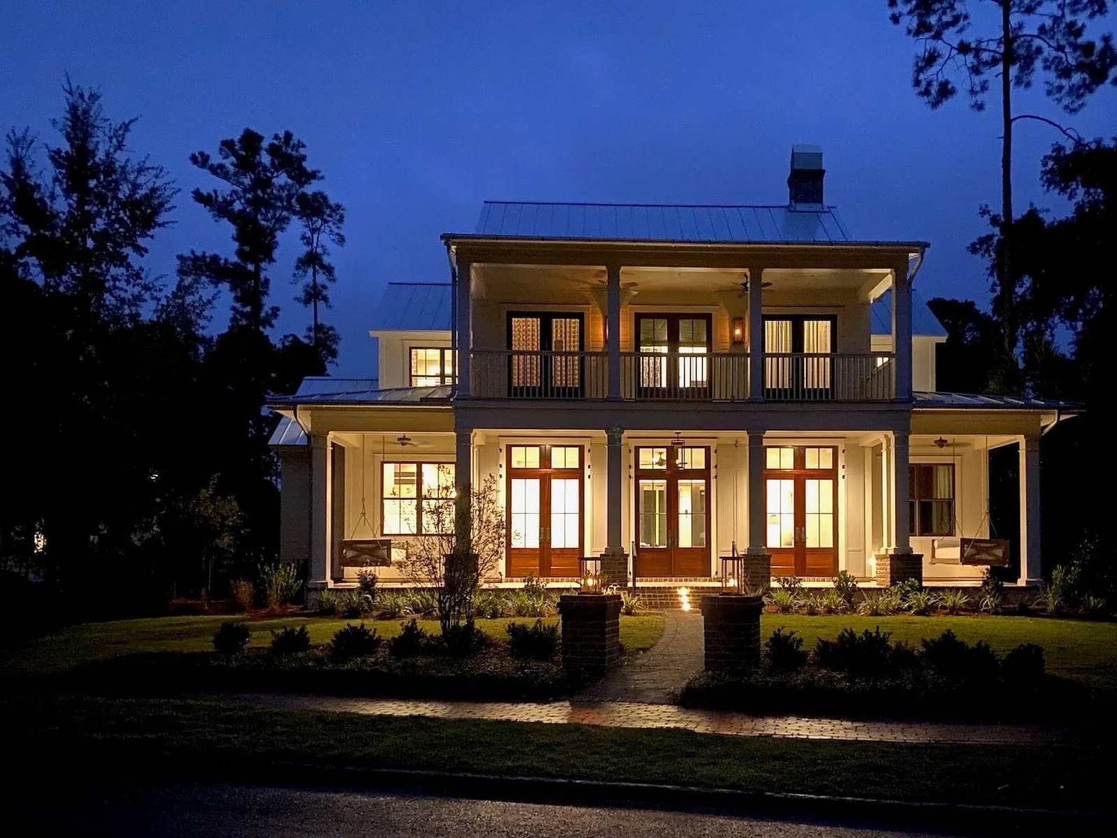 Night time view of a custom home in Palmetto Bluff with all the lights on using KKC Property Management for their home watch services.