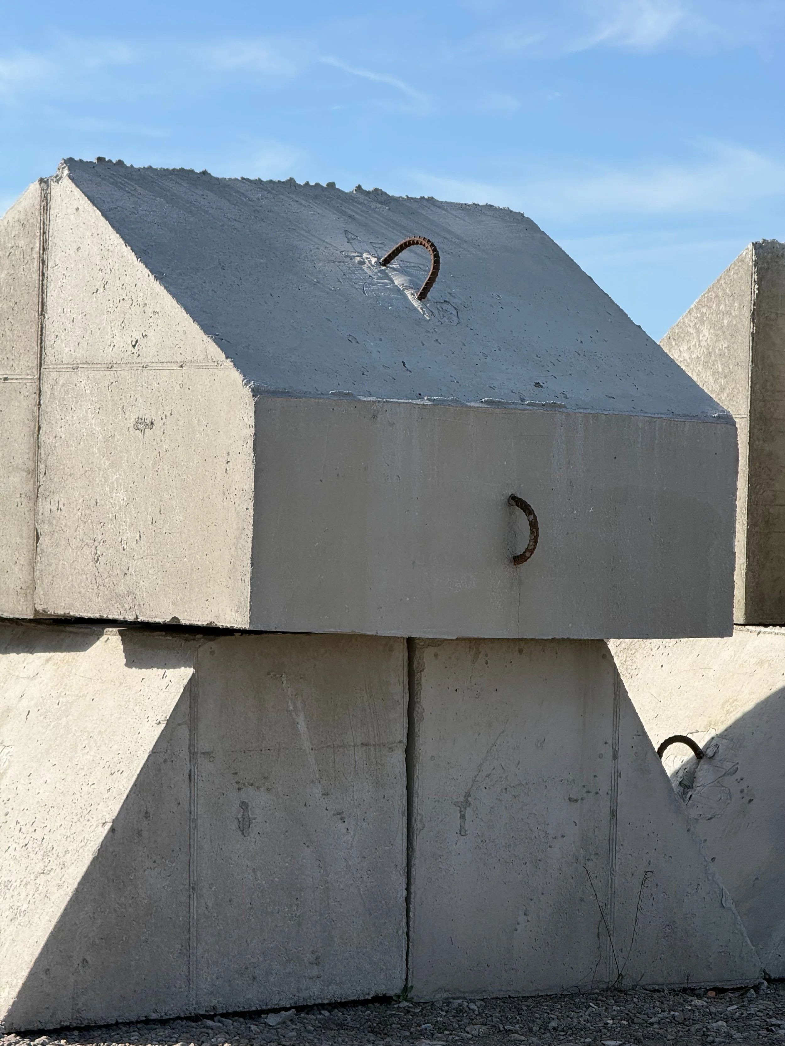Precast concrete dock anchors staged in product yard