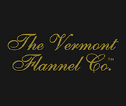 Logo of The Vermont Flannel Co. with gold cursive text on a black background.