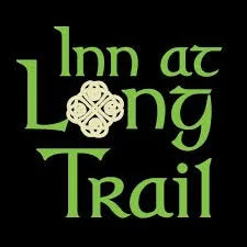 Logo for Inn at Long Trail with green text and a decorative emblem on a black background.