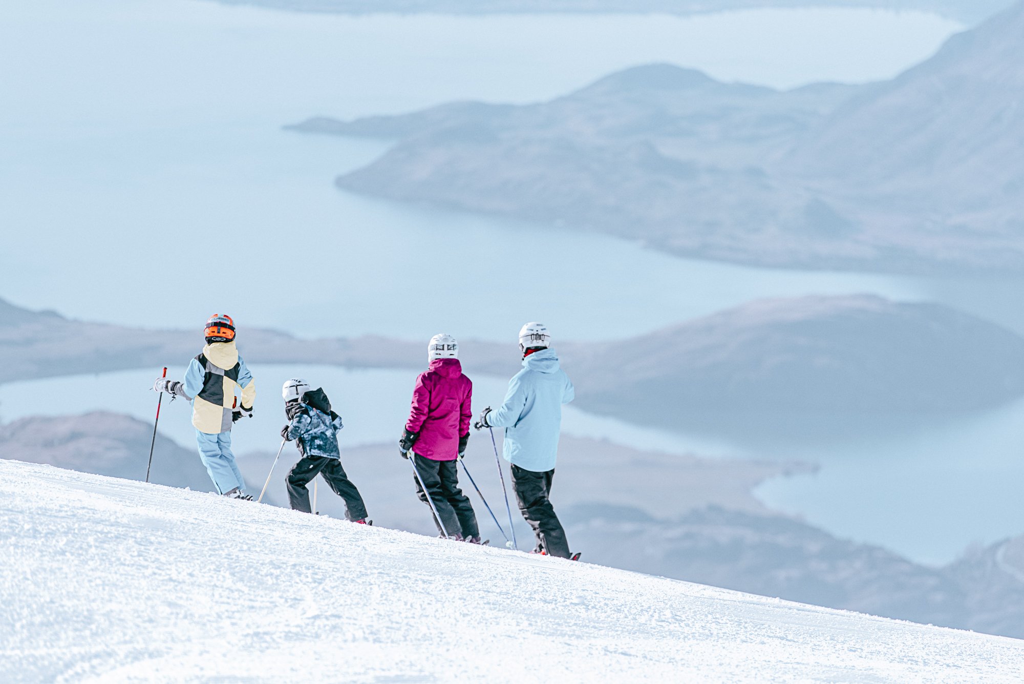 A family enjoying the view on a ski outing at Treble Cone Ski Area, New Zealand