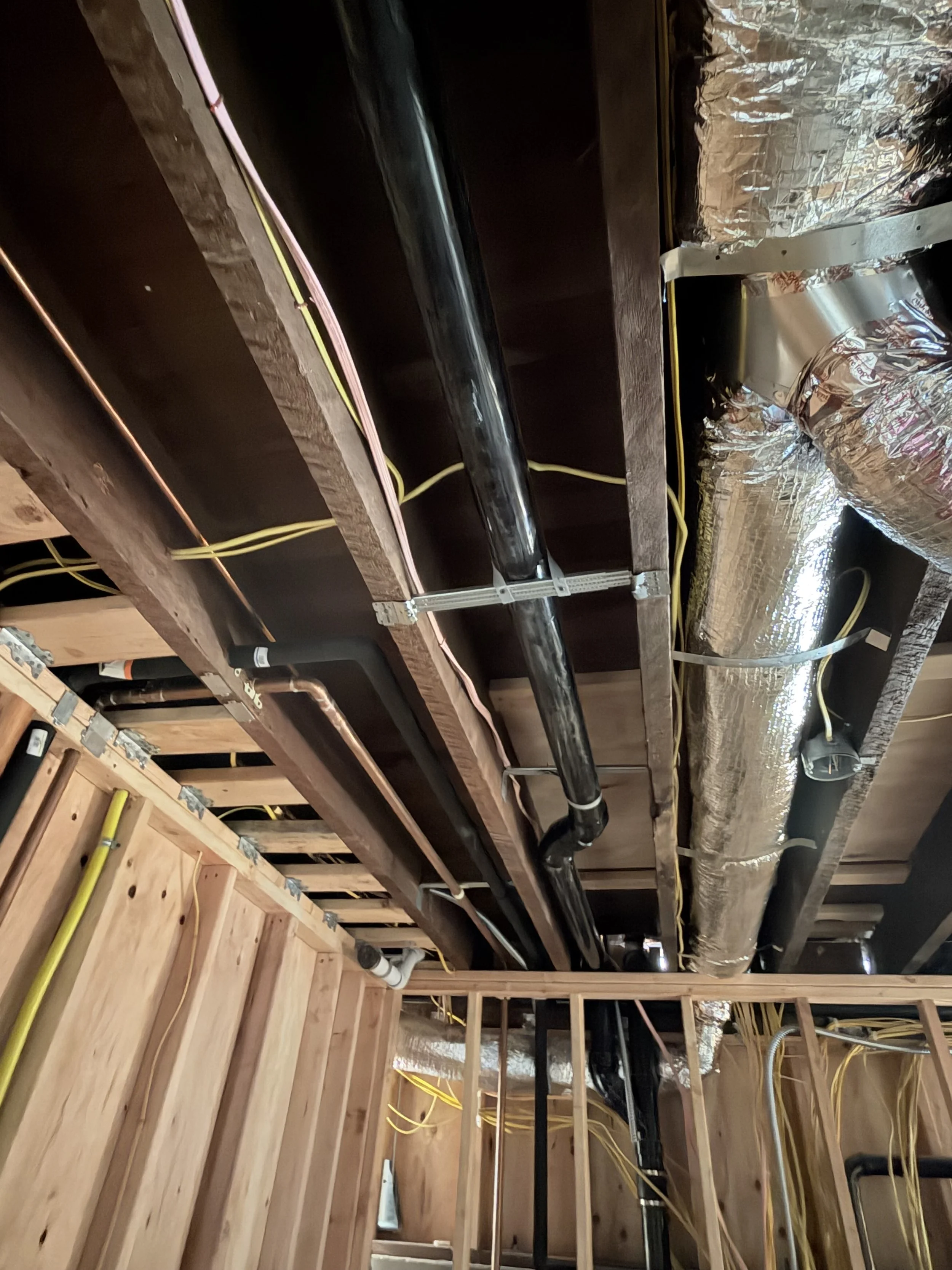 basement plumbing electrical in bays.jpeg