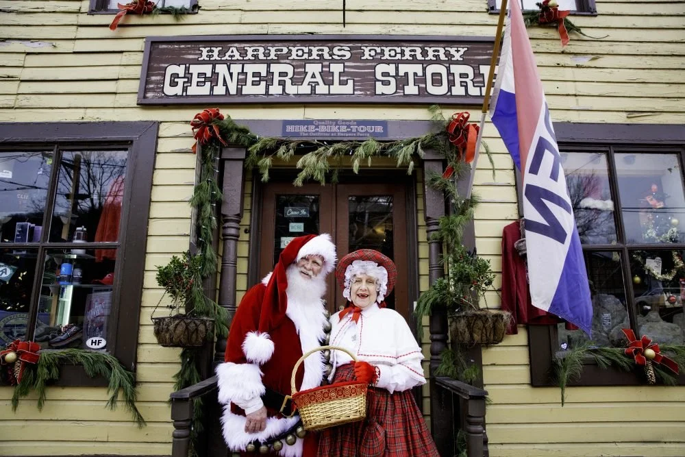 vintage santa and mrs claus standing in front of Harpers Ferry General Store