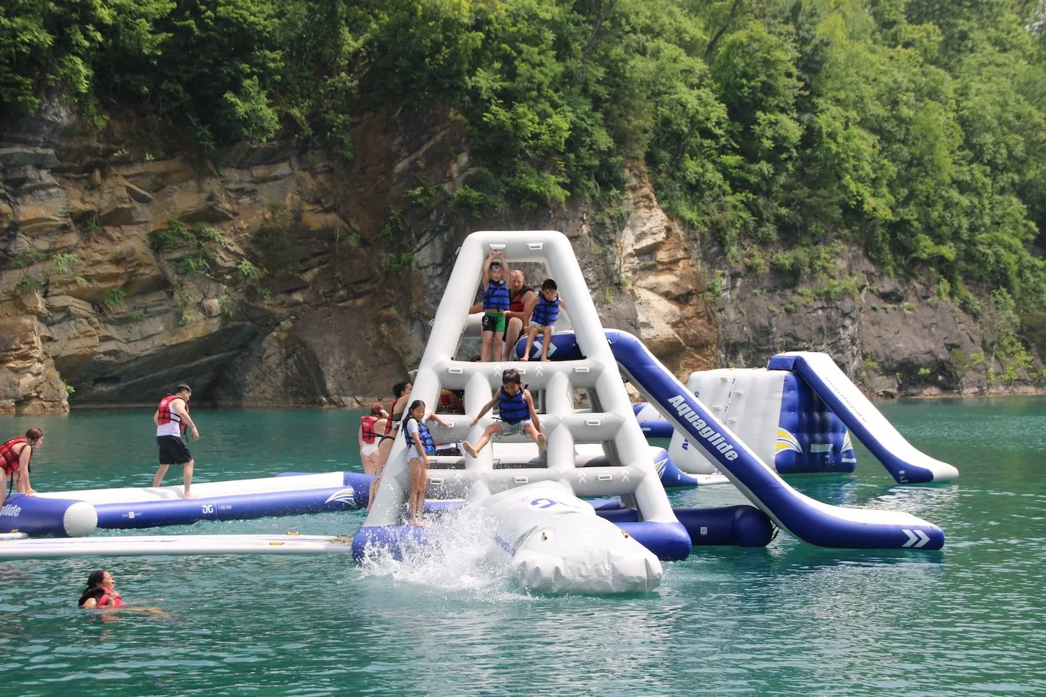 kids playing on inflatable at waterpark