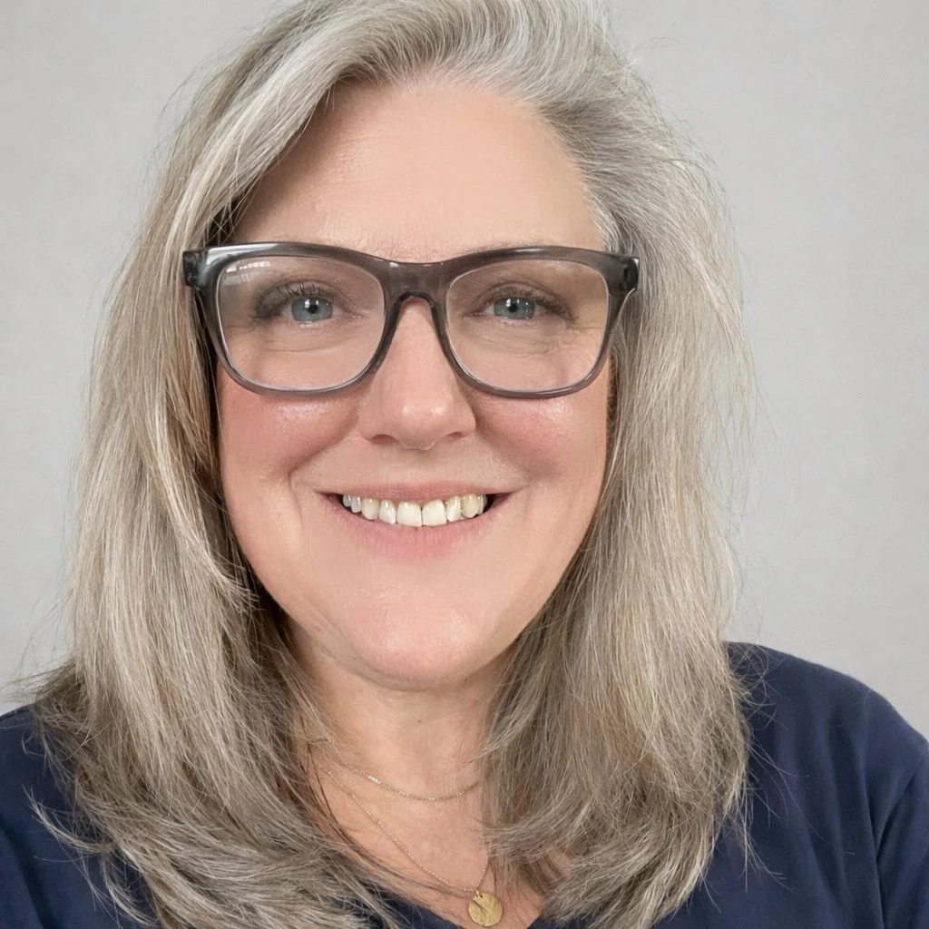 Woman with blond hair and glasses