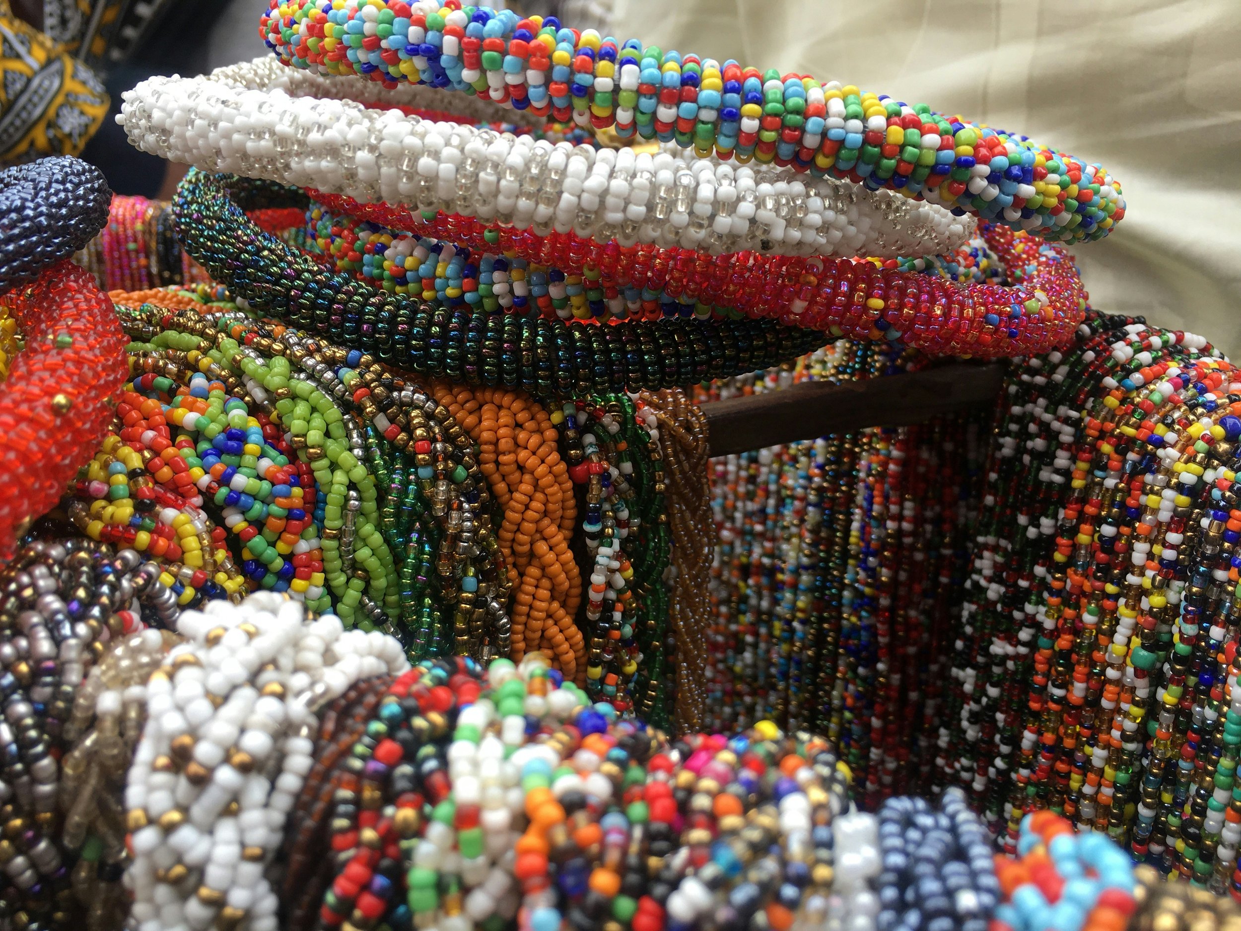 Colorful beaded bracelets stacked on a display.