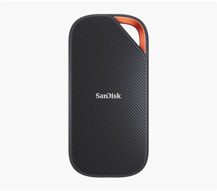 A black SanDisk portable external solid-state drive with a textured surface and rounded edges, featuring a red/orange accent in the top corner.