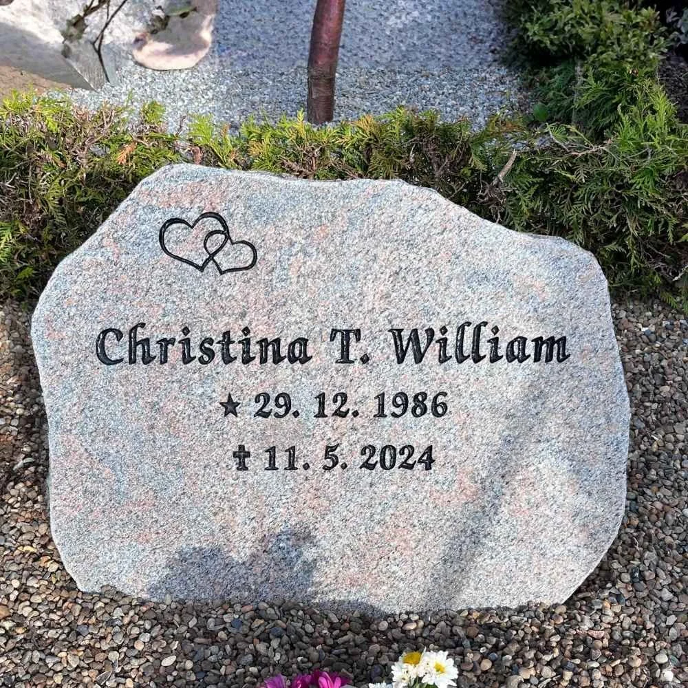 Gravestone with the name Christina T. William, birth date December 29, 1986, and death date May 11, 2024, decorated with two heart drawings.