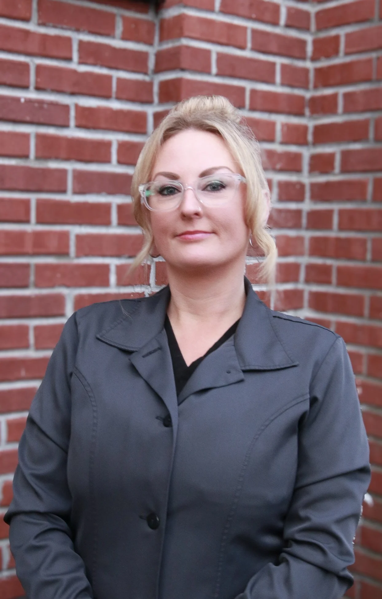 Portrait of Amber standing in front of the Kendall Dental building