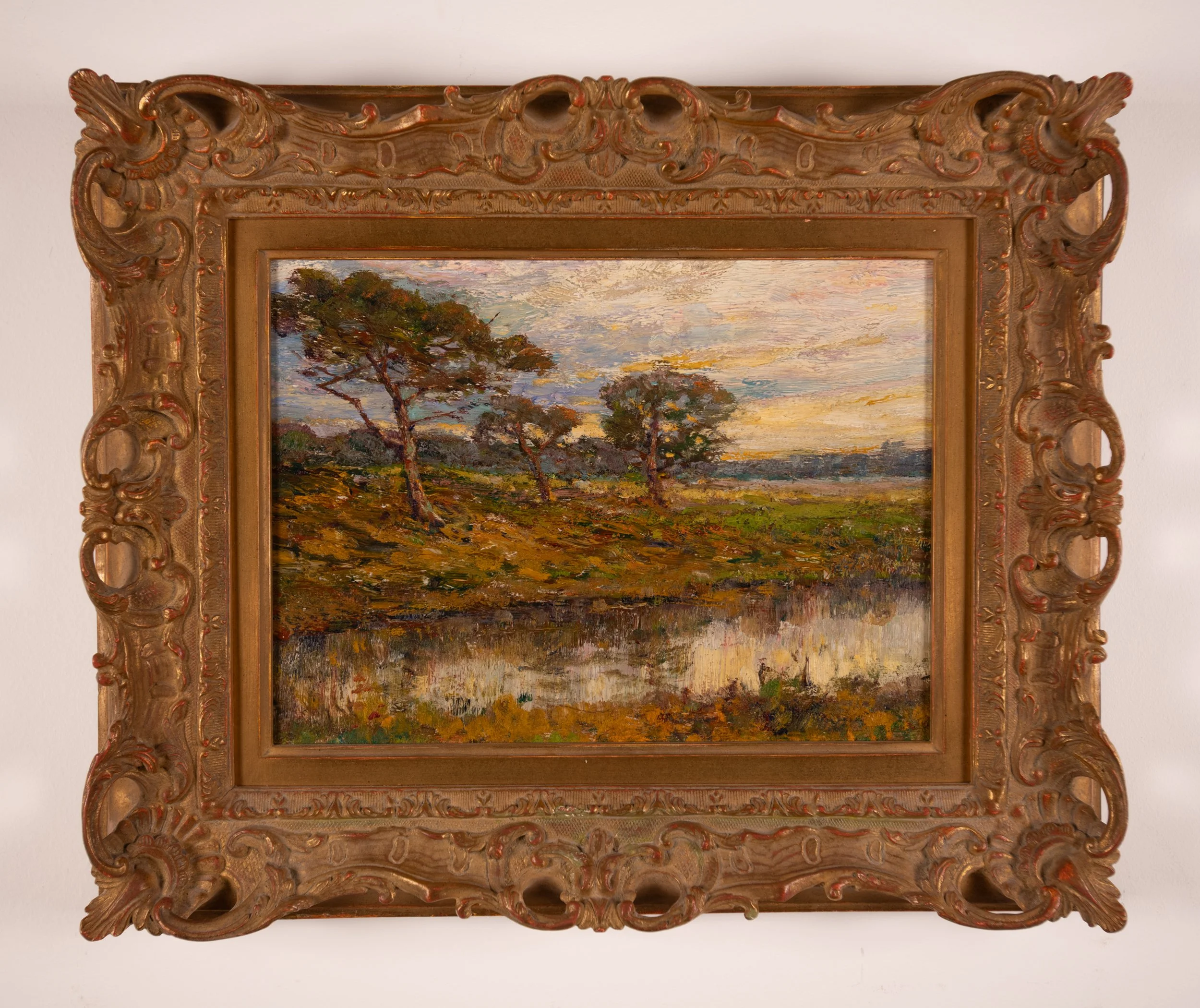 Impressionistic vista of wind swept pines on pond edge