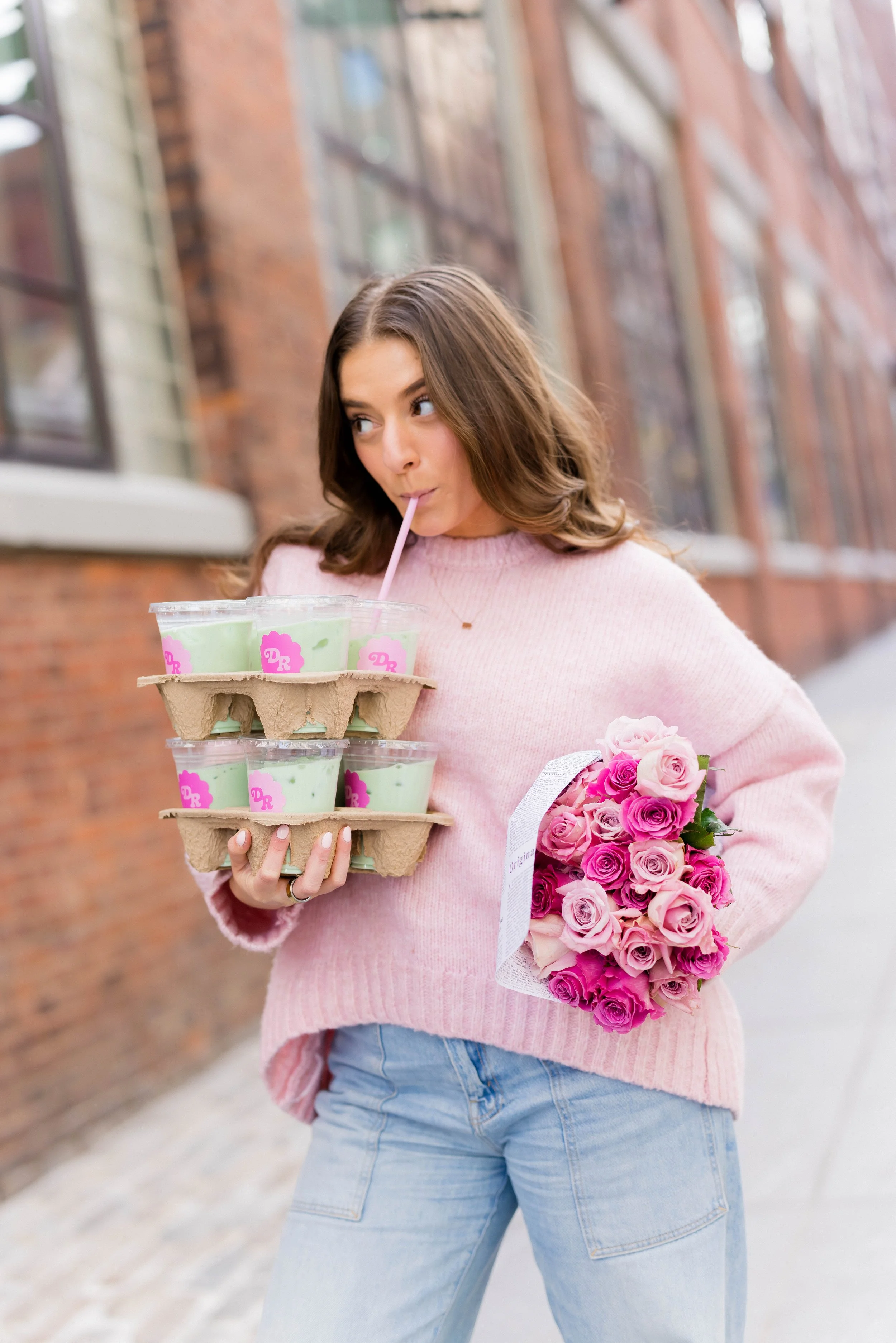 NYC Instagram coach with Daily Randi branded matcha and pink roses showcasing community-inspired lifestyle content