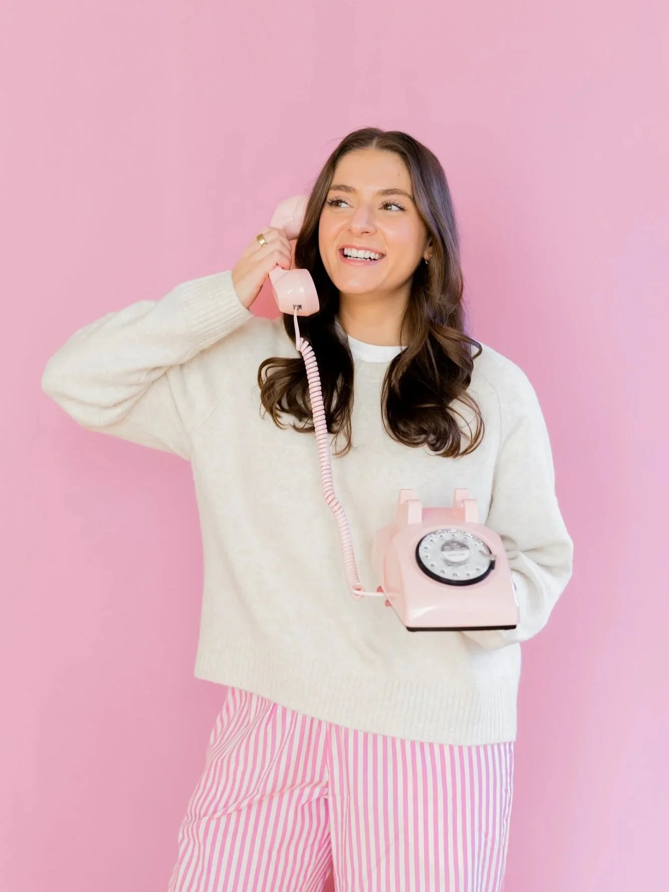 Instagram coach on pink vintage phone ready to connect with business owners seeking content strategy guidance