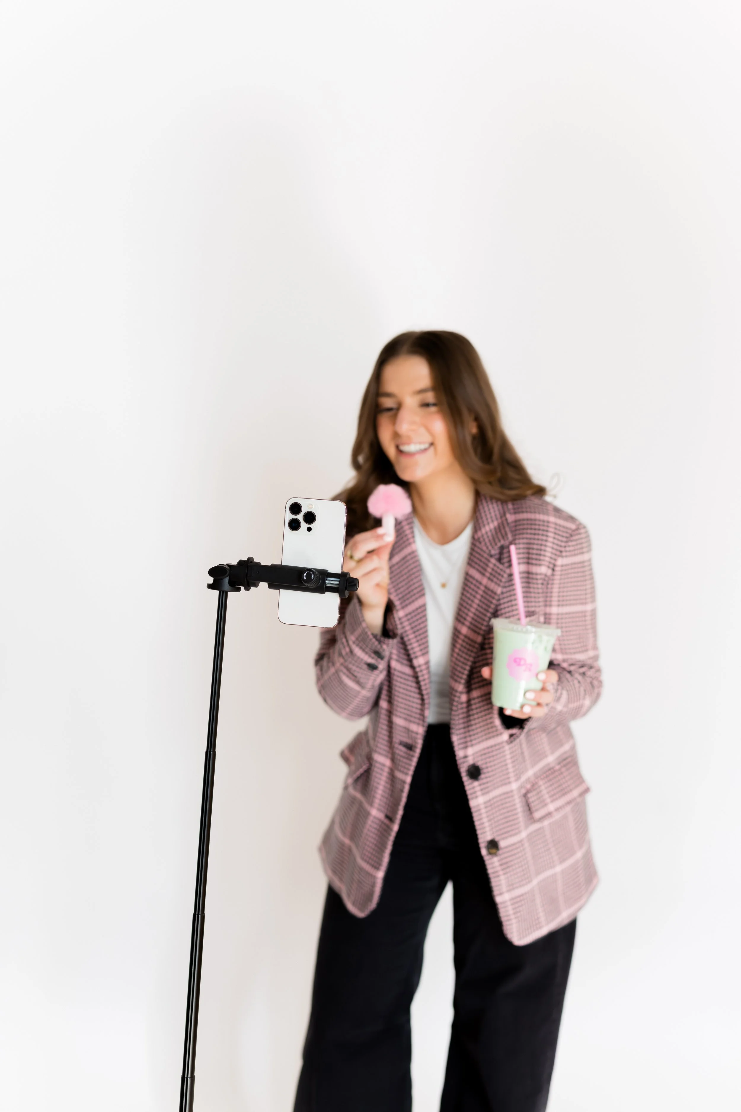 Instagram coach setting up phone tripod with ring light and matcha for content creation tutorial