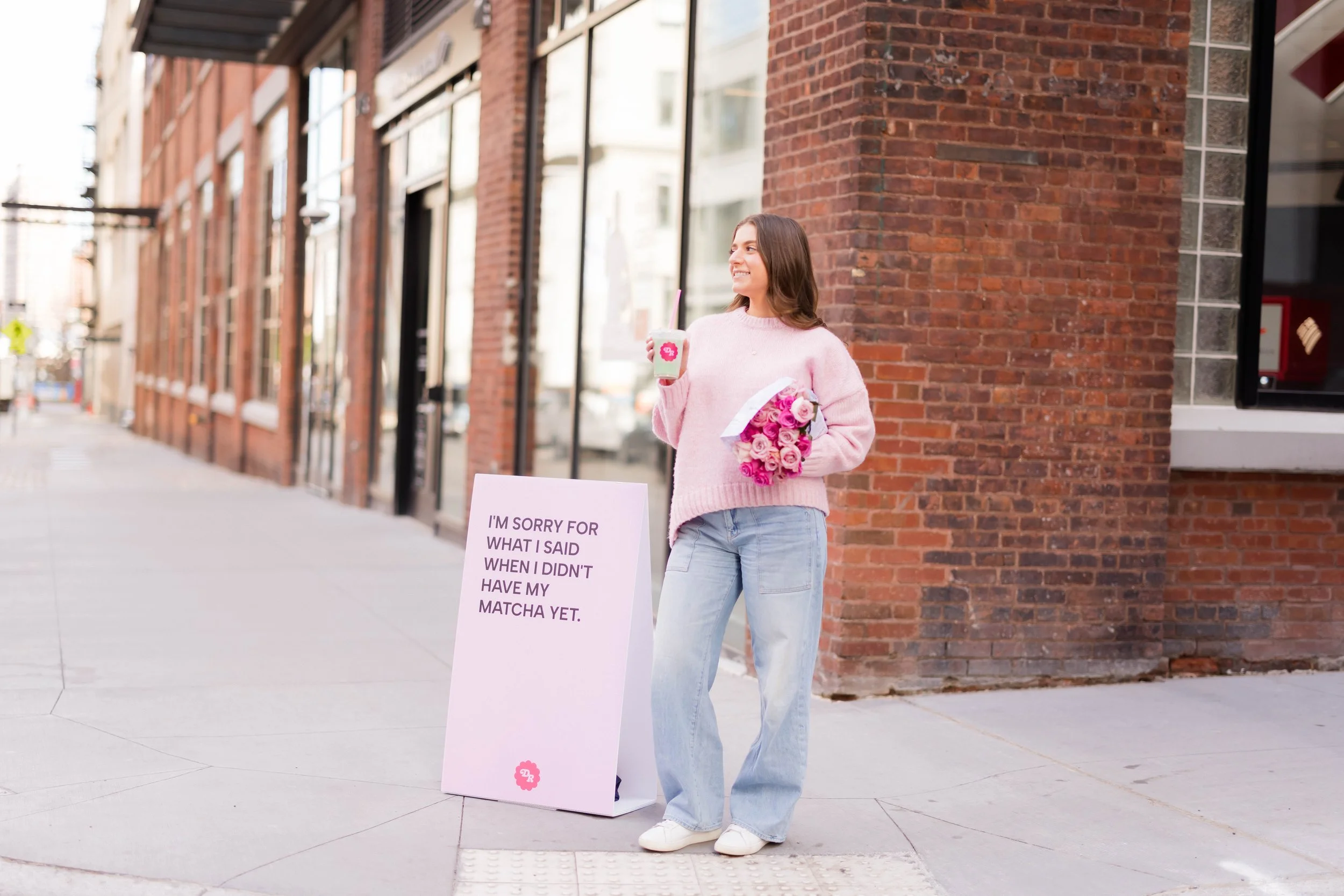 NYC Instagram coach with Daily Randi branded matcha and flowers on city street, embodying authentic content creation