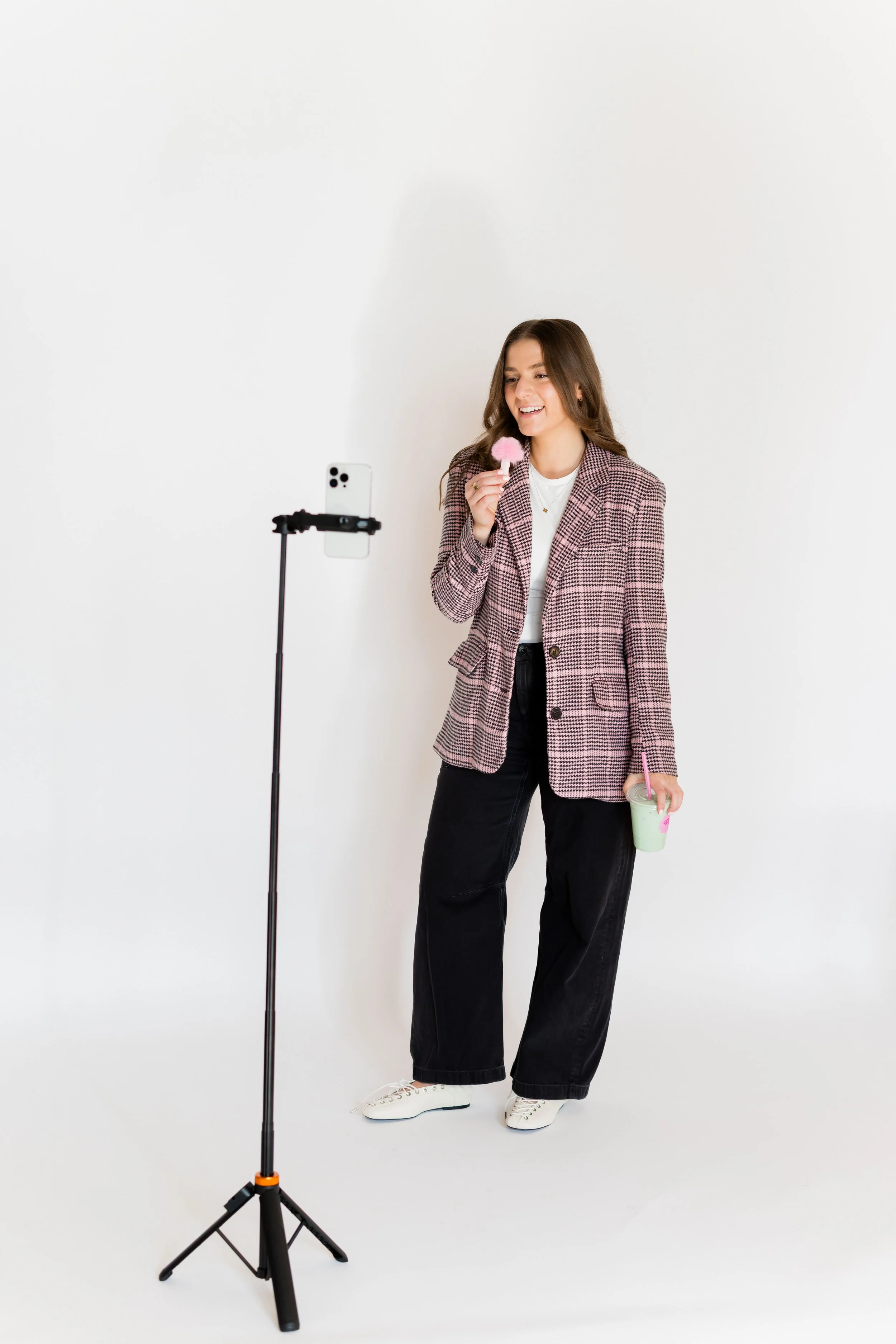 Instagram content creator using phone tripod and ring light to film professional Reels for business growth