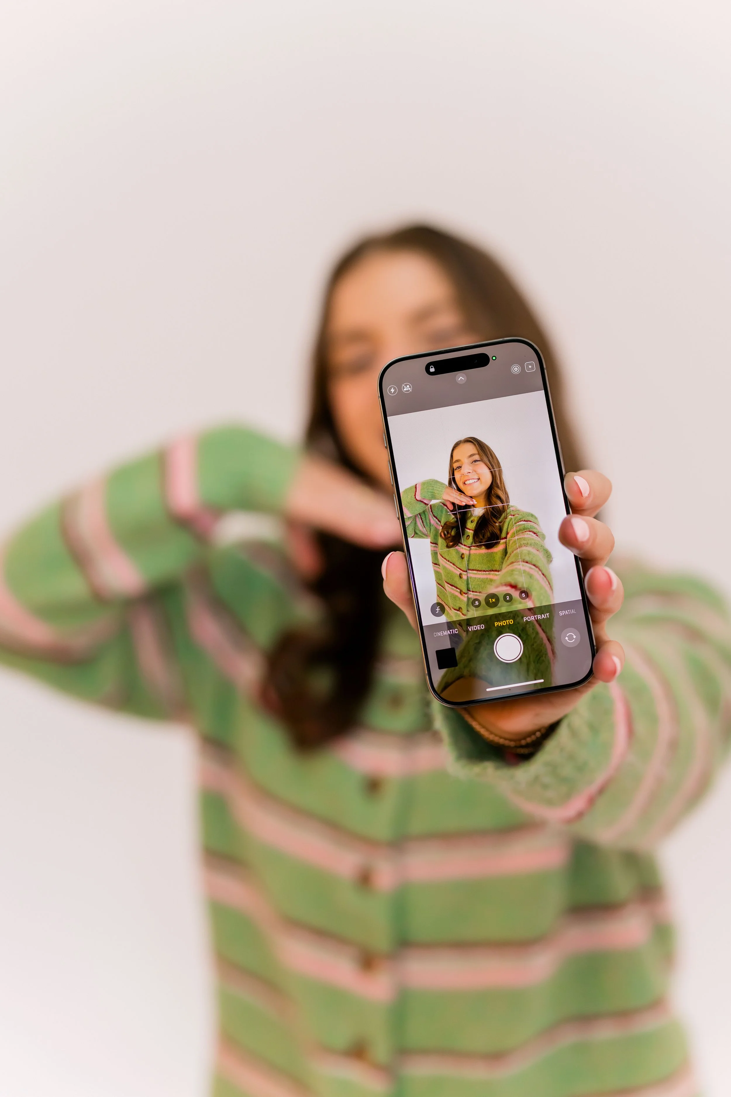 Content creator showing phone screen with Instagram filming techniques for community members learning social media strategy