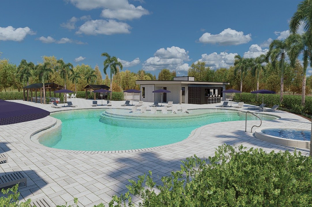 Swimming pool area with lounge chairs, umbrellas, a hot tub, surrounded by palm trees and greenery under a partly cloudy sky.