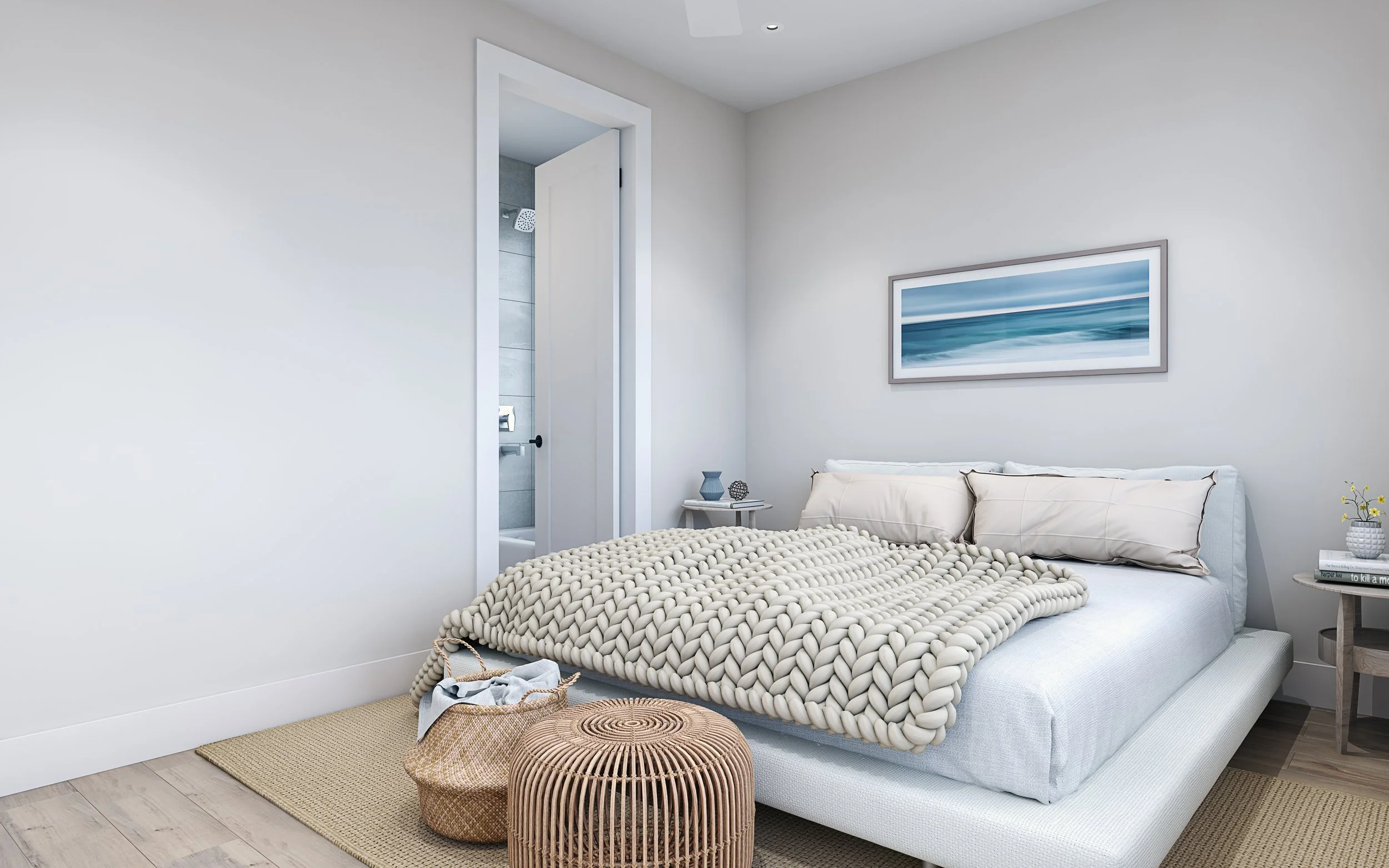 Modern bedroom with white bed, textured blanket, beige pillows, abstract blue ocean art, side tables with decorative items, basket, and doorway to an en-suite bathroom.