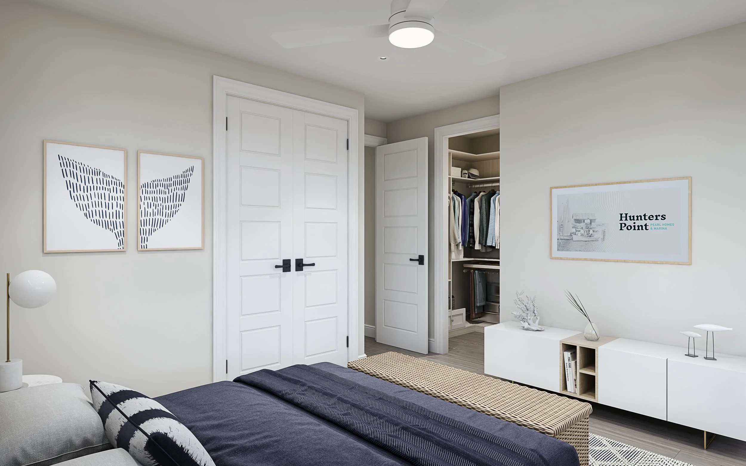 A modern bedroom with a bed, wall art, a ceiling fan, a dresser, and a walk-in closet.