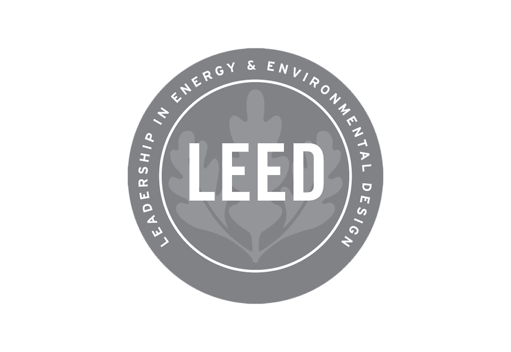 LEED certification emblem for leadership in energy and environmental design with a leaf graphic in the background.