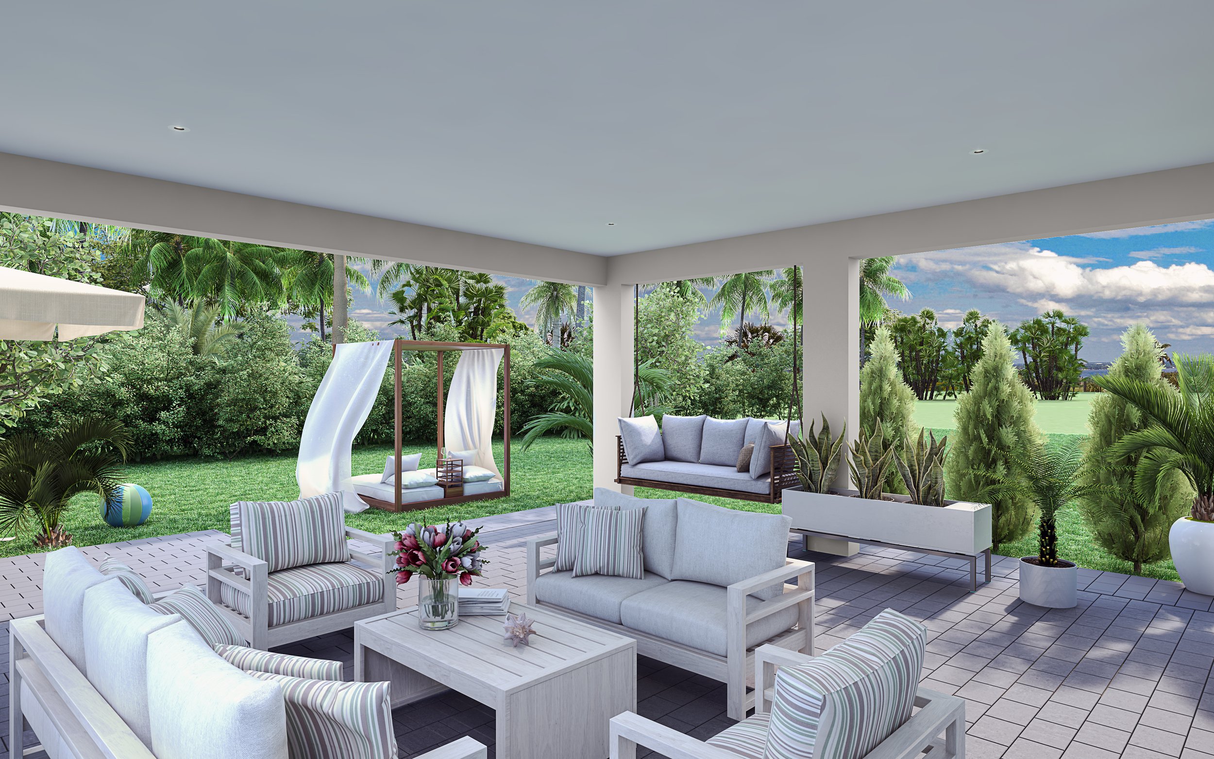 Bright outdoor patio with white furniture, striped cushions, a glass vase with flowers on a table, potted plants, and views of tropical greenery and trees.