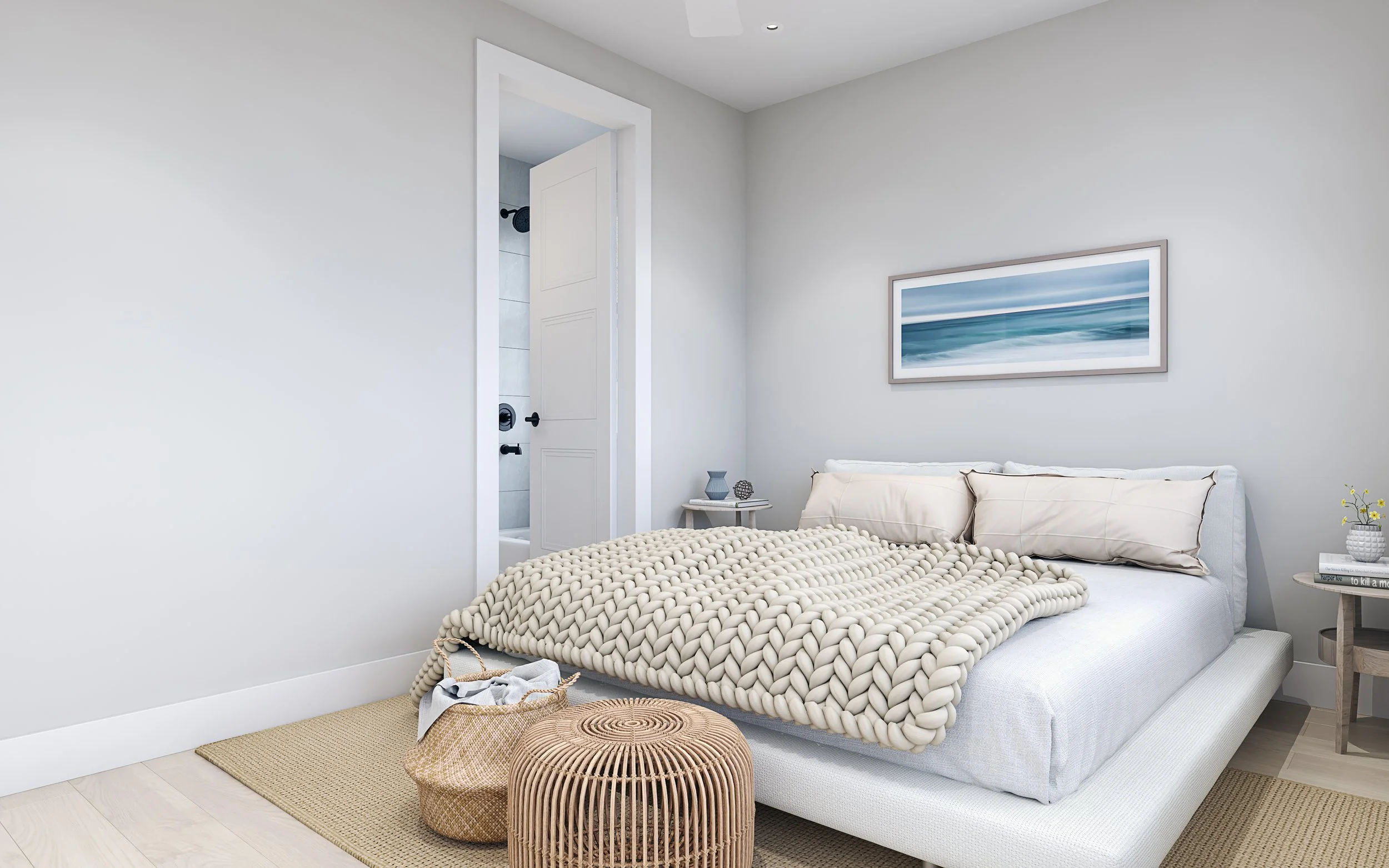 Fresh and clean bedroom with a white bed, beige chunky knit blanket, two beige pillows, side tables with decorative objects, wall art, and an open door to a bathroom.