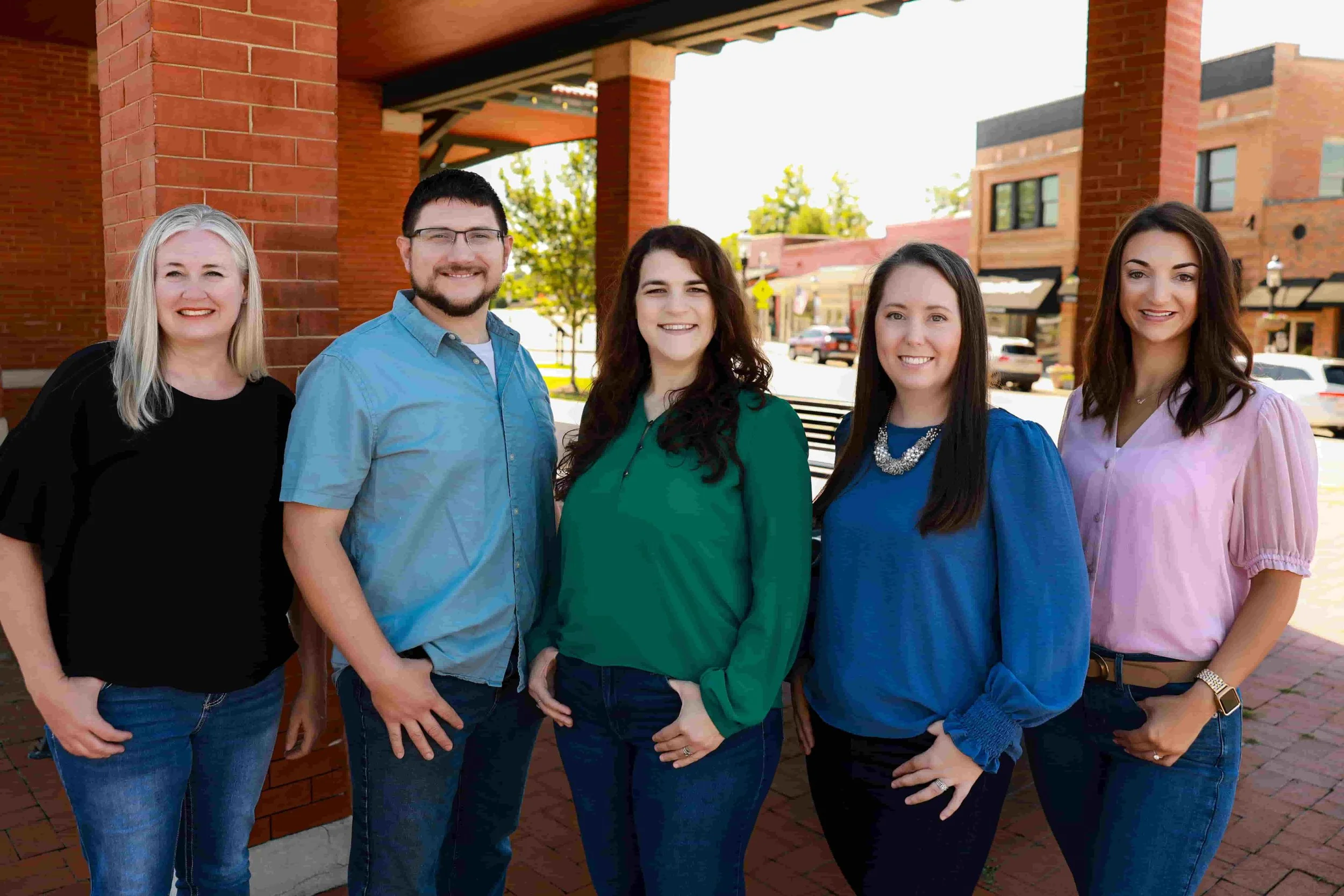 The team at Balow Accounting Services - Group of five women and one man standing outside near a brick building, smiling at the camera.