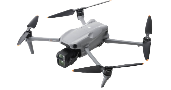 A gray quadcopter drone with four black propellers, a built-in camera underneath, and a streamlined body.